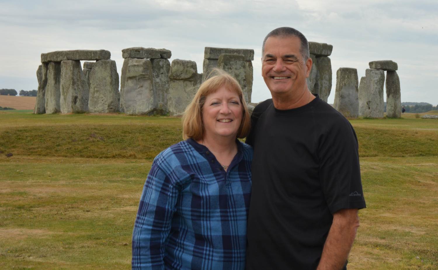 Castaway Destinations clients posing together in front of Stonehenge during a sightseeing tour in England.