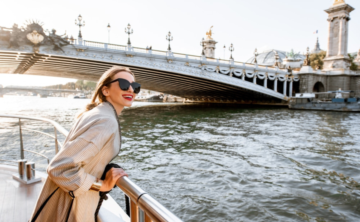 Solo traveler enjoying scenic views from the sun deck of a European river cruise ship