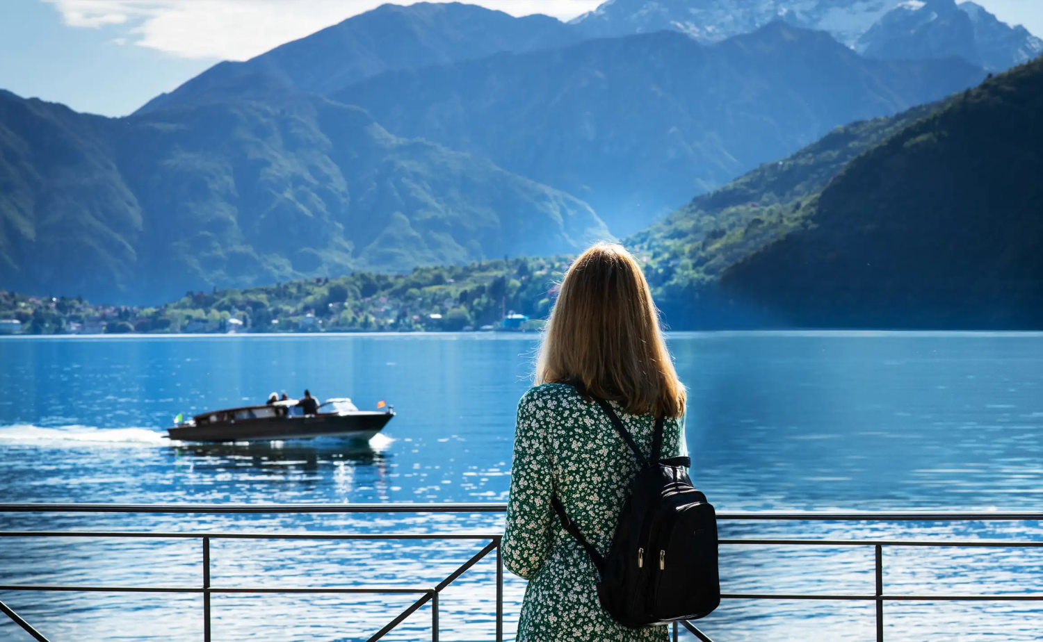 Solo traveler admiring peaceful alpine scenery during a European river cruise journey