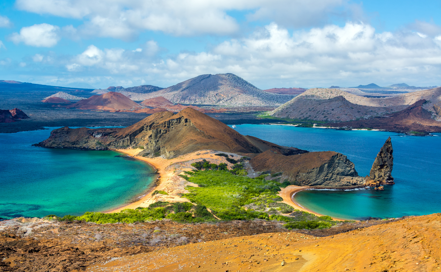 Volcanic Galápagos landscape surrounded by turquoise bays and dramatic rock formations.