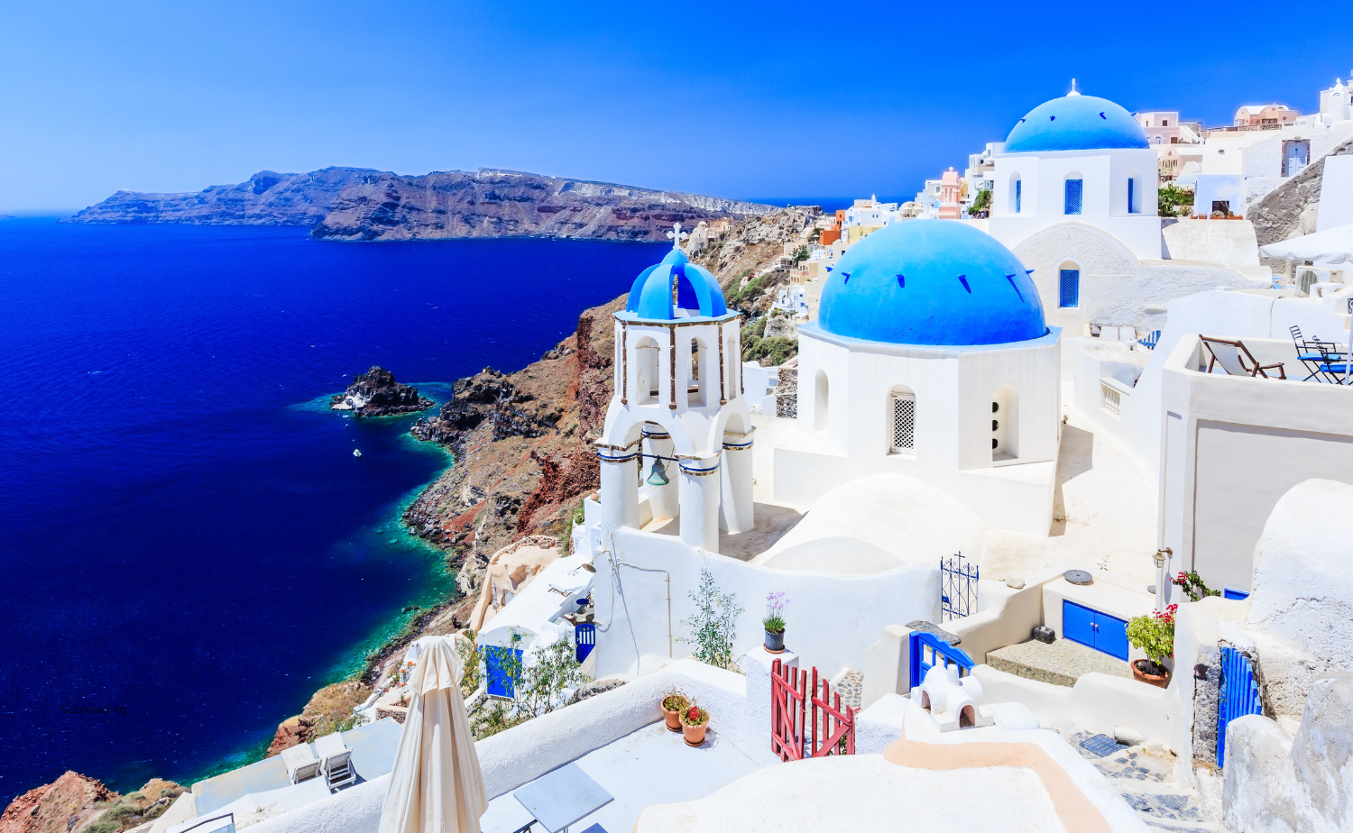 Iconic blue-domed churches overlooking the Aegean Sea in Santorini, Greece