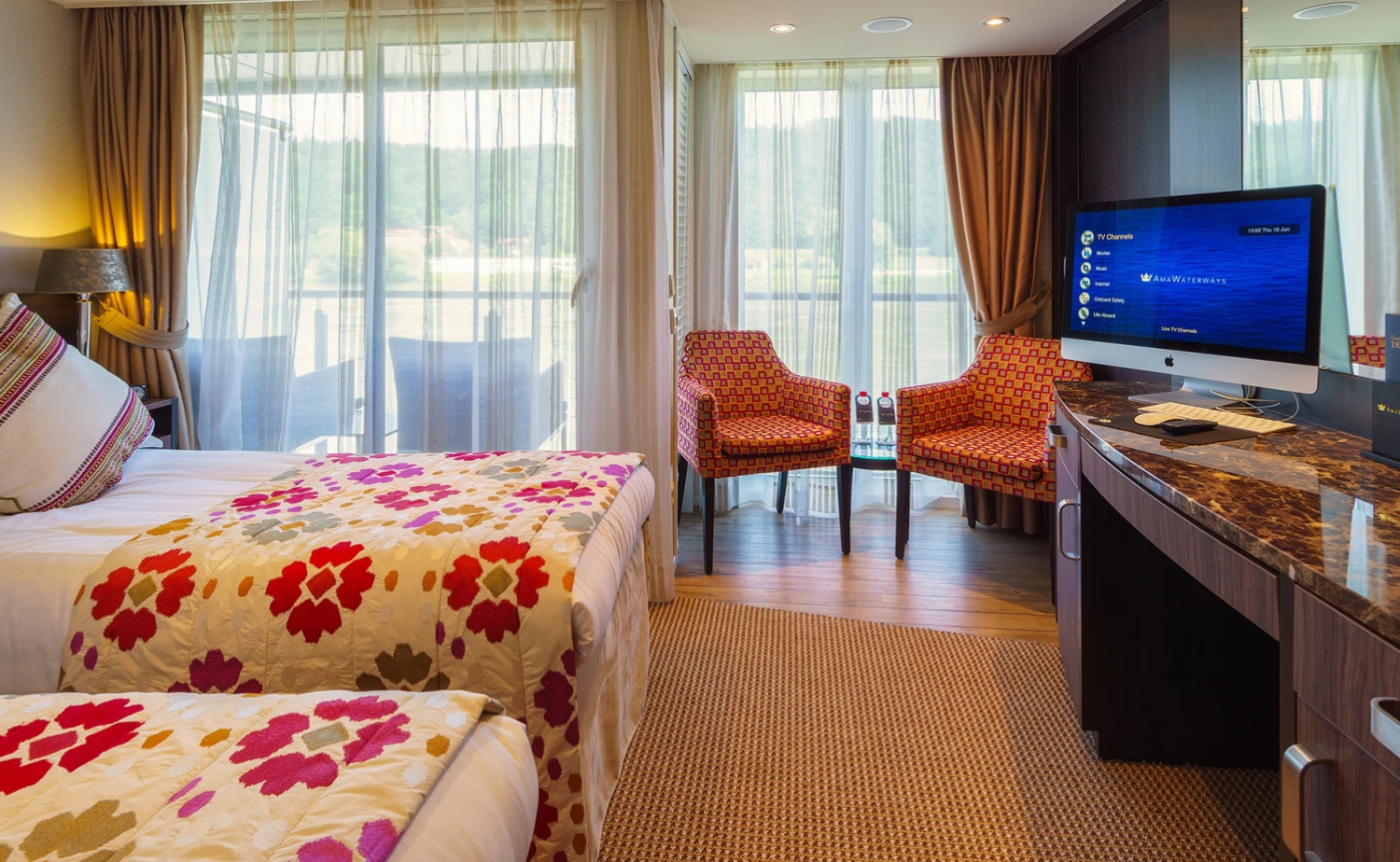 Spacious river cruise stateroom with large windows and accommodations suitable for family travel