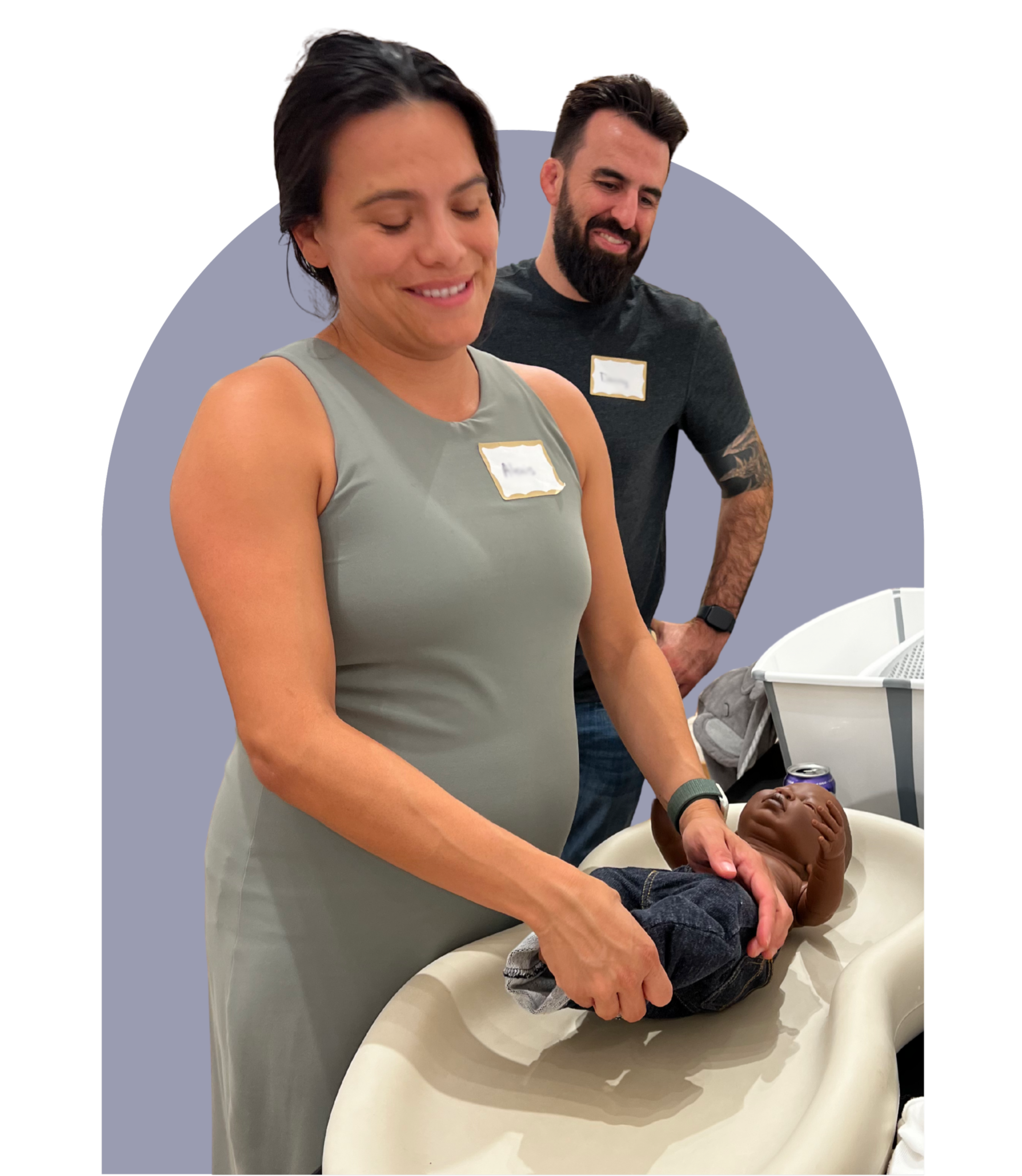 Two students practicing diapering on a baby doll
