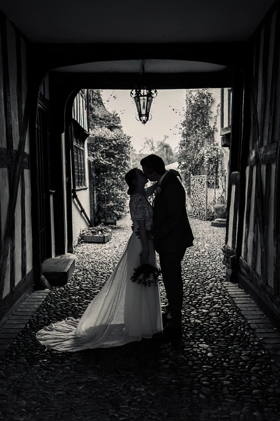 Black and white photo of bride and groom embracing at The Greyfriars in Worcester