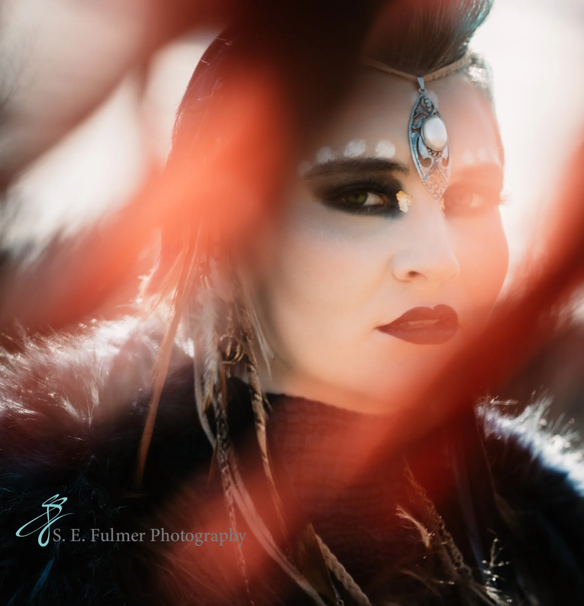 High school senior, Holly, MI. Woman with dramatic makeup, ornate headpiece, and feathers. Cosplay photography.