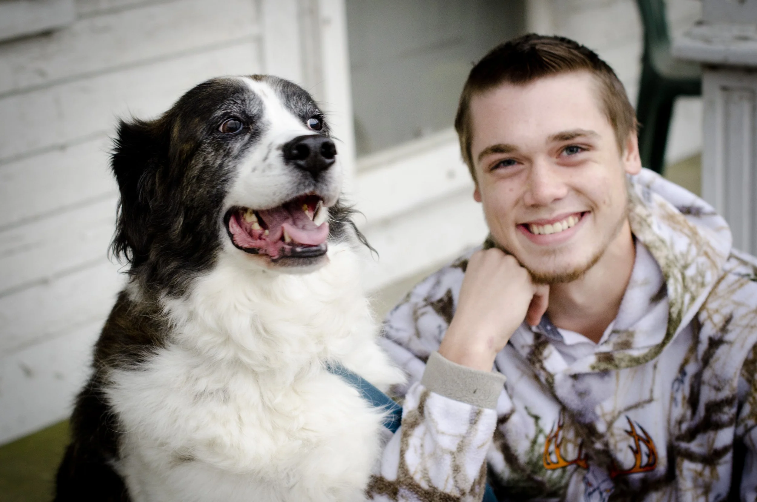 High school senior, Ortonville, MI. A smiling man with his dog.