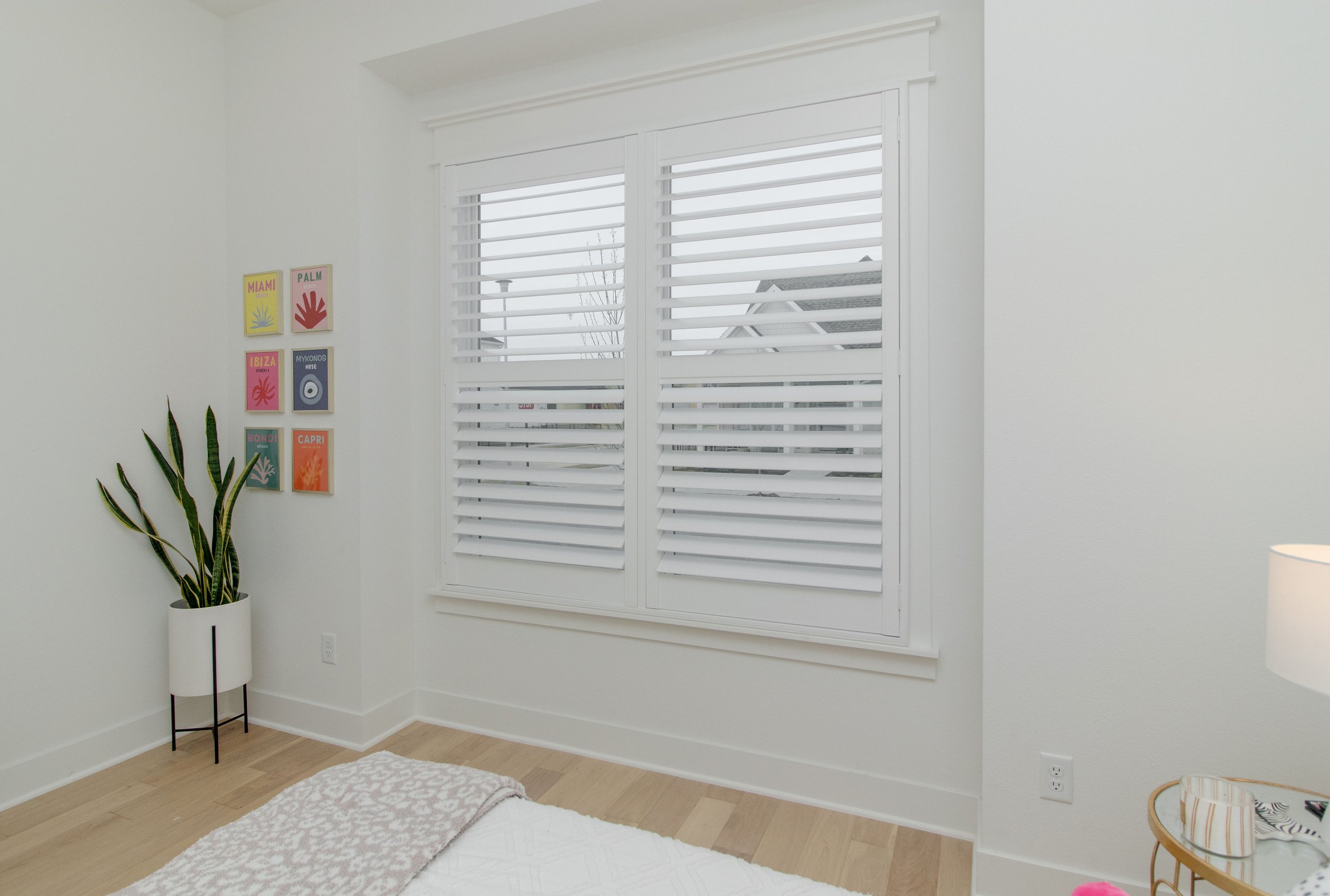 Craftsman frame shutters with bright white 3.5-inch louvers in a Northwest Arkansas bedroom.