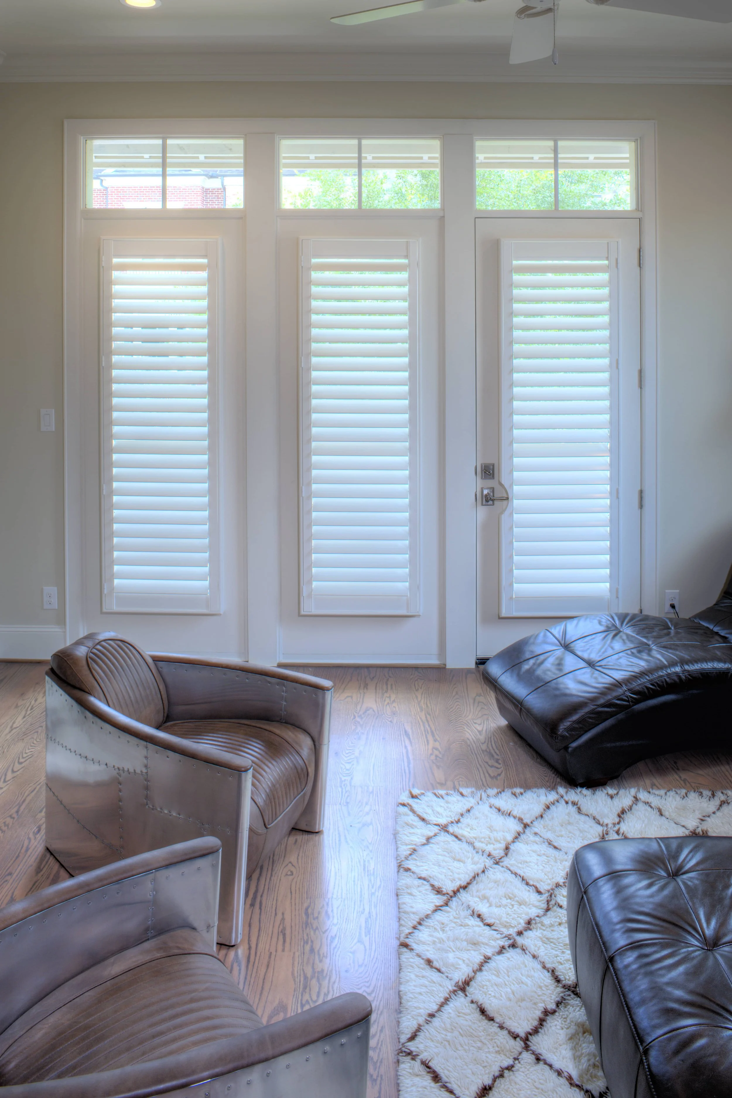 Custom ClearLine shutters cover French doors and windows in a The Woodlands, Texas living room.