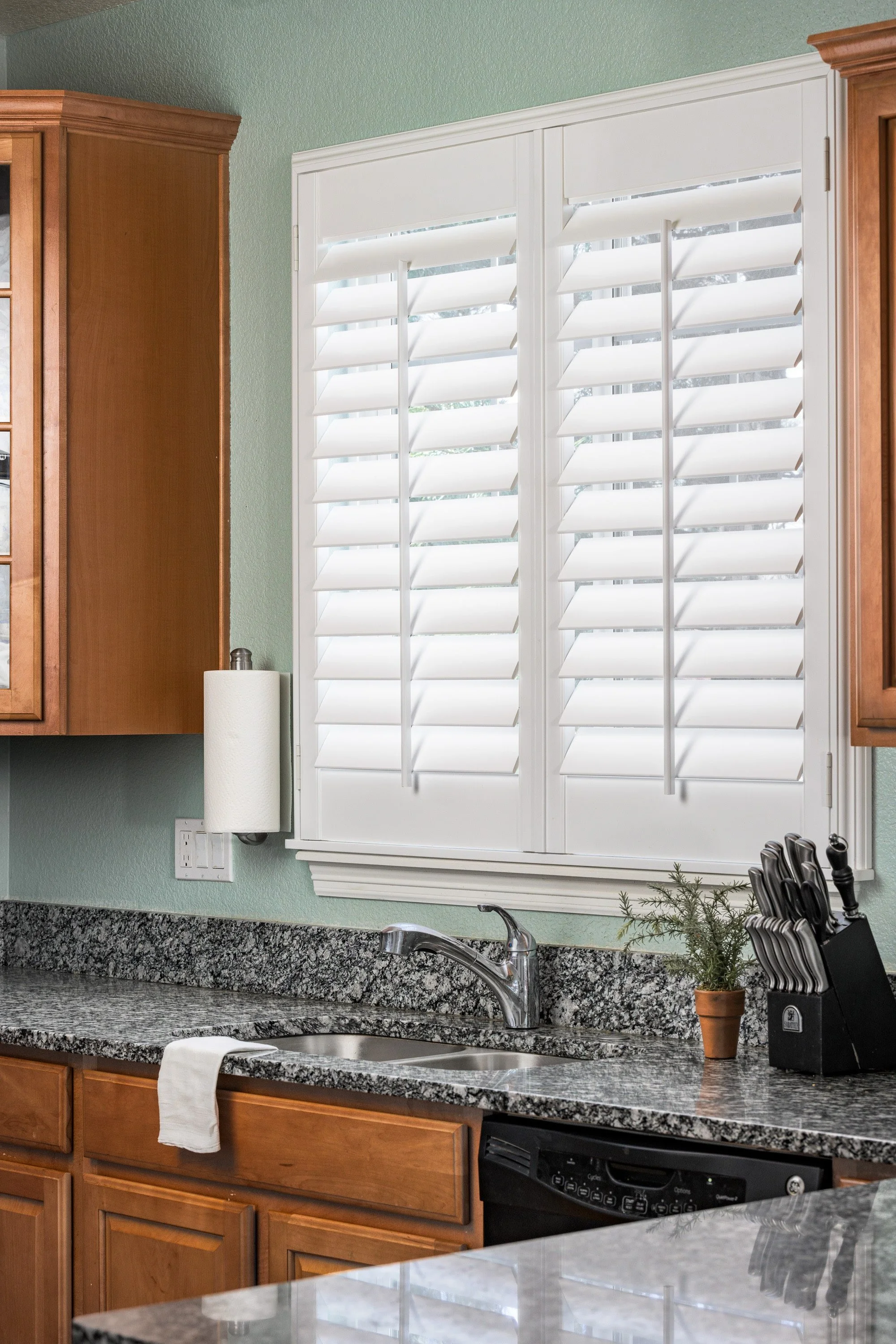 Bright white plantation shutters over kitchen sink in the Colorado Classic home.