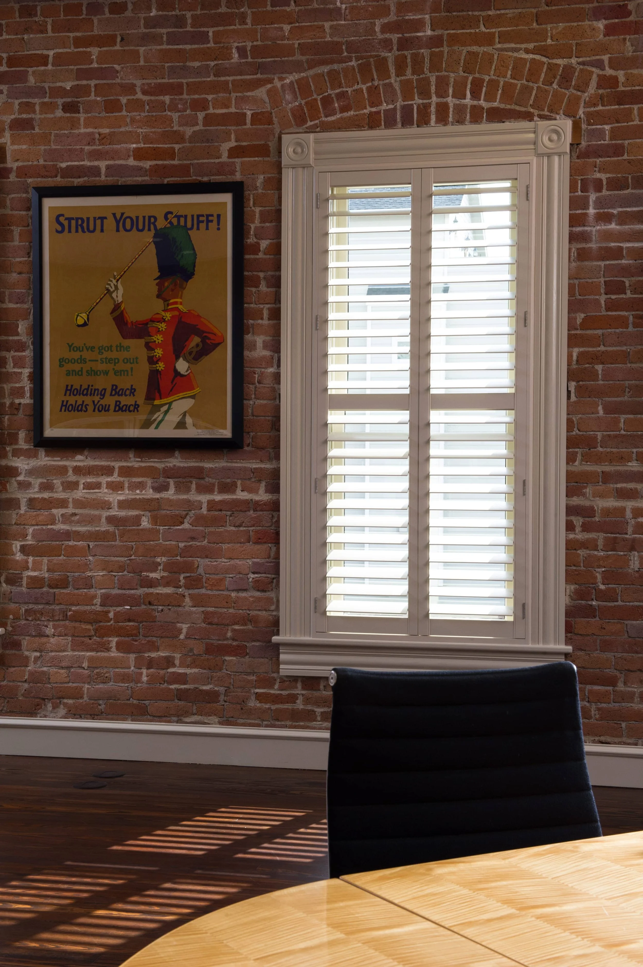 White custom shutters with ClearLine tilt installed against exposed brick in a St. Louis firehouse.