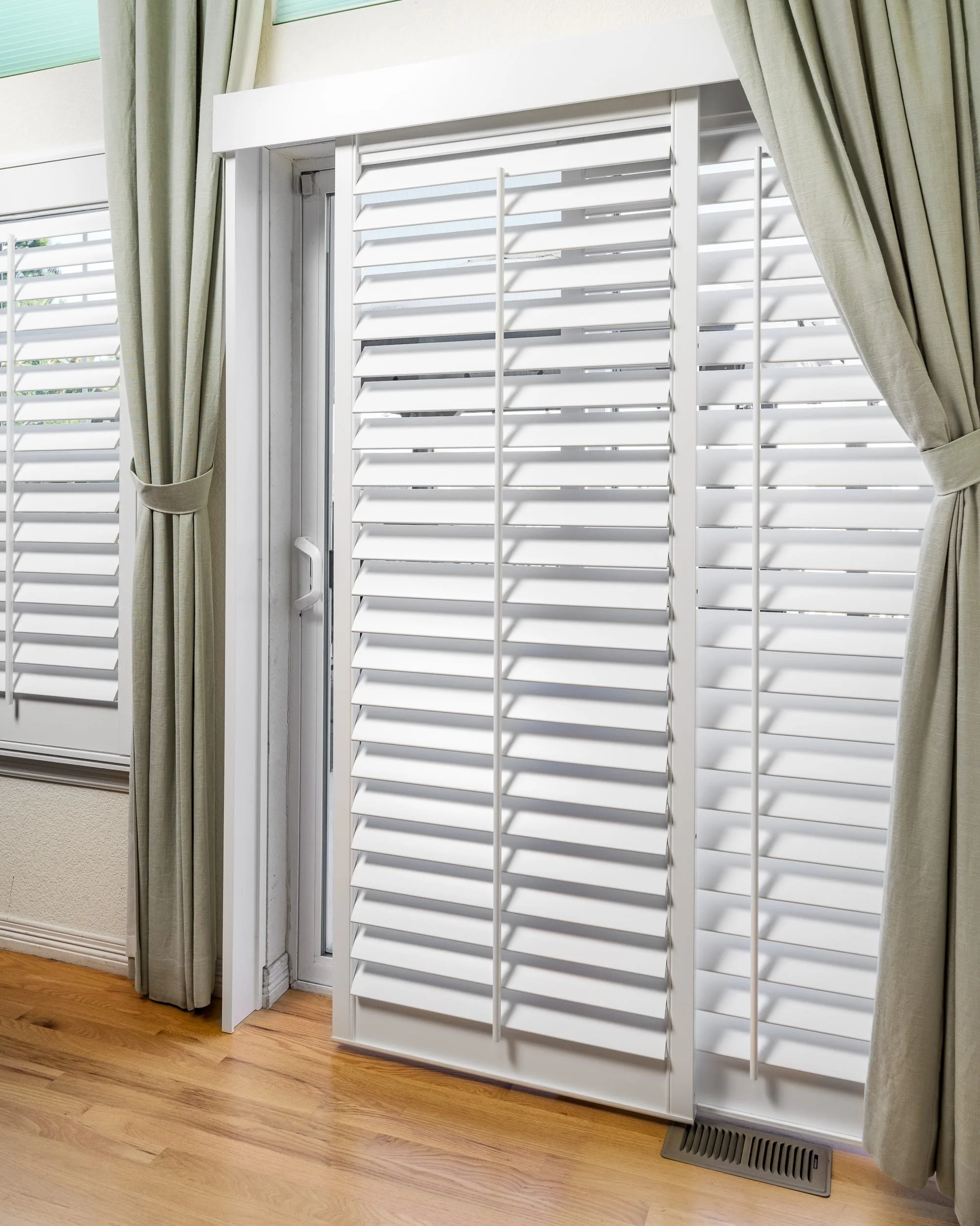 Plantation shutters installed over sliding glass door in the Colorado Classic home.