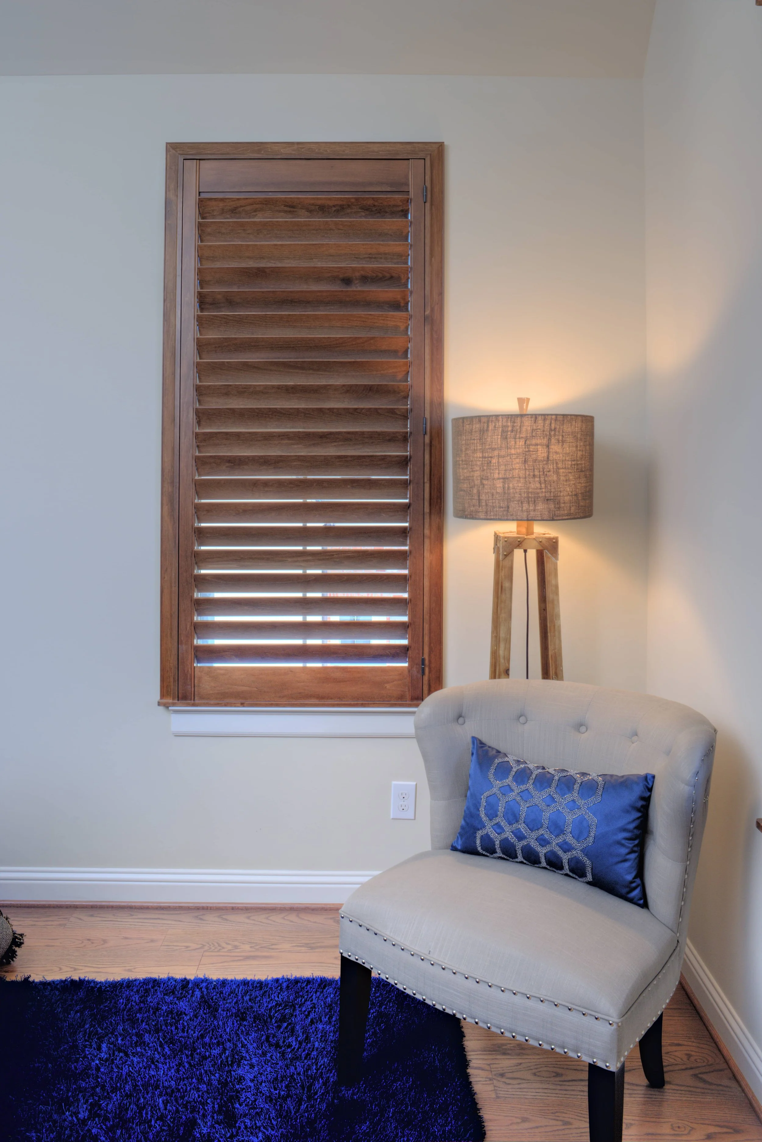 Terrace stained wood shutter on a bedroom window in a The Woodlands, Texas home.
