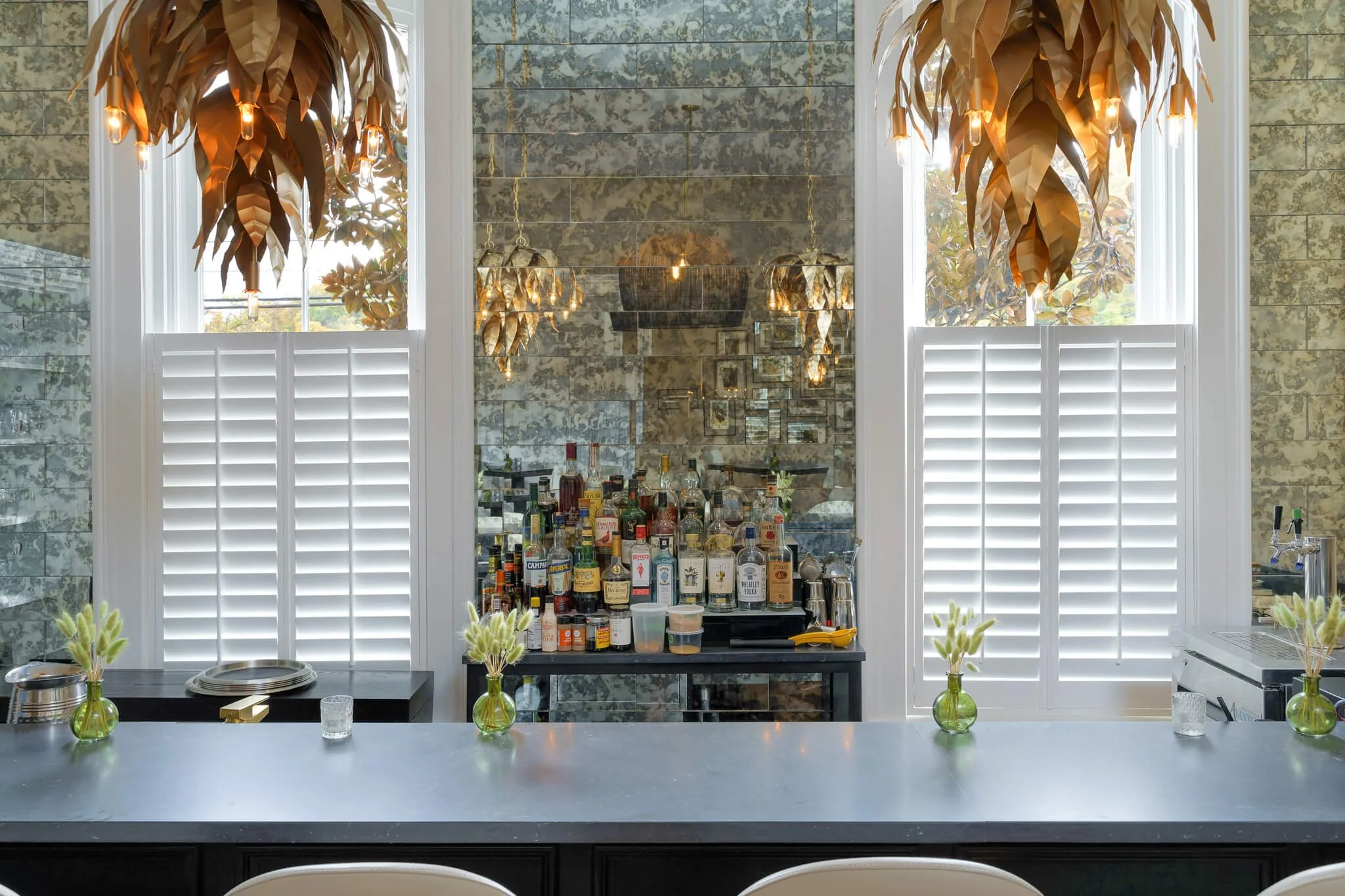 White café-style shutters on tall bar windows at Limewater Bistro in Frankfort, Kentucky.