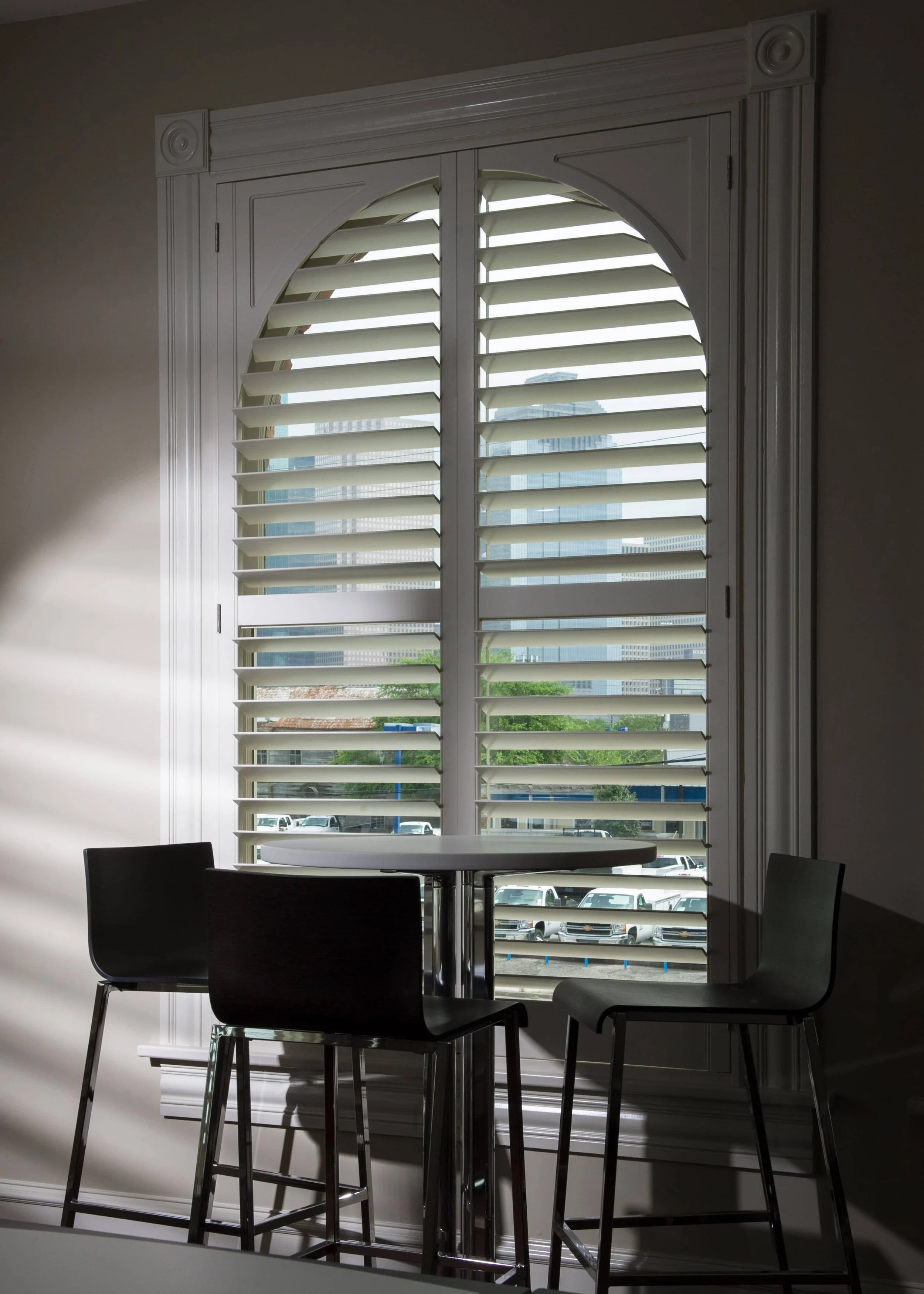 Custom arched shutter designed to follow a specialty window in a St. Louis firehouse.