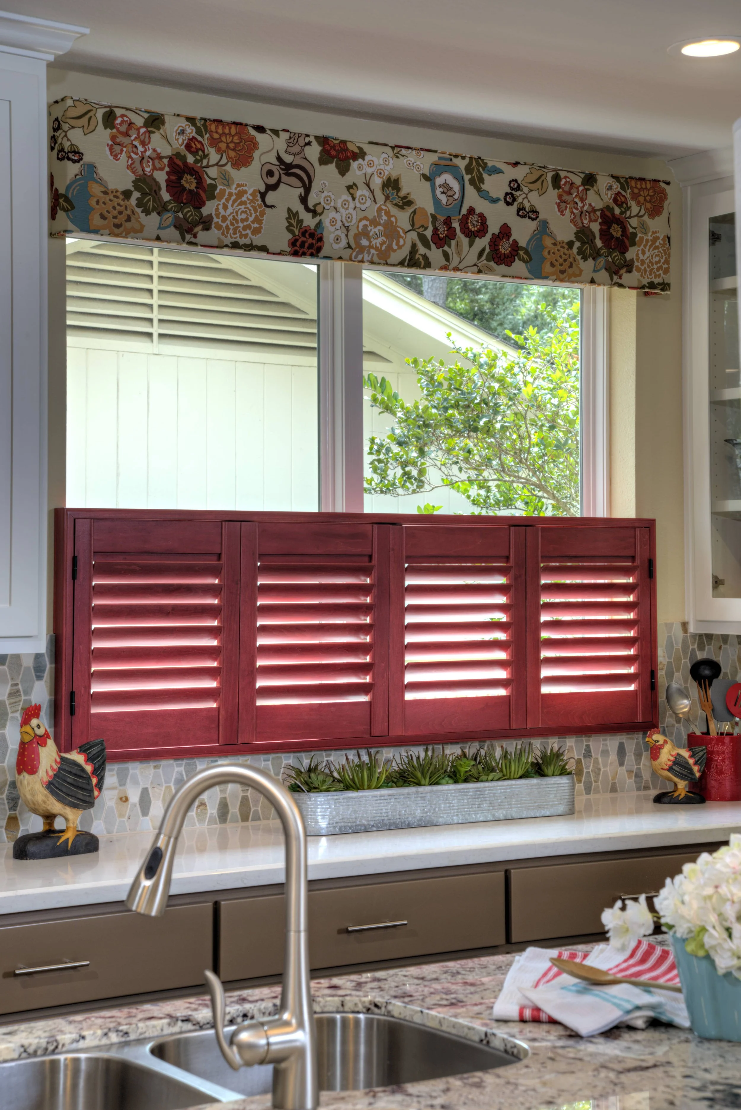 Custom red stained shutters with ClearLine tilt on a kitchen window in a Houston, Texas home.