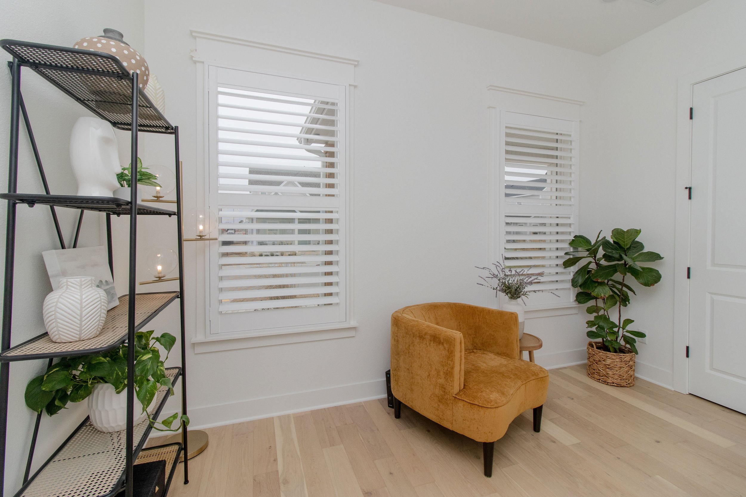 Bright white Craftsman frame shutters with 3.5-inch louvers in a Northwest Arkansas sitting room.
