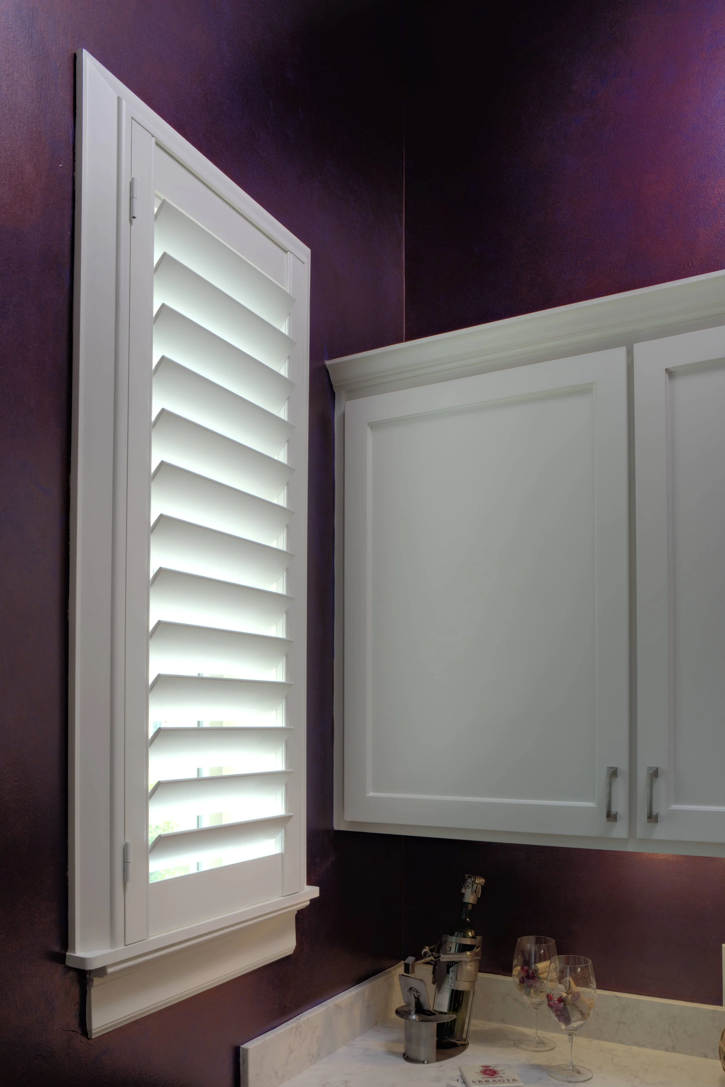 White ClearLine shutter custom fitted to a laundry room window in a The Woodlands, Texas home.