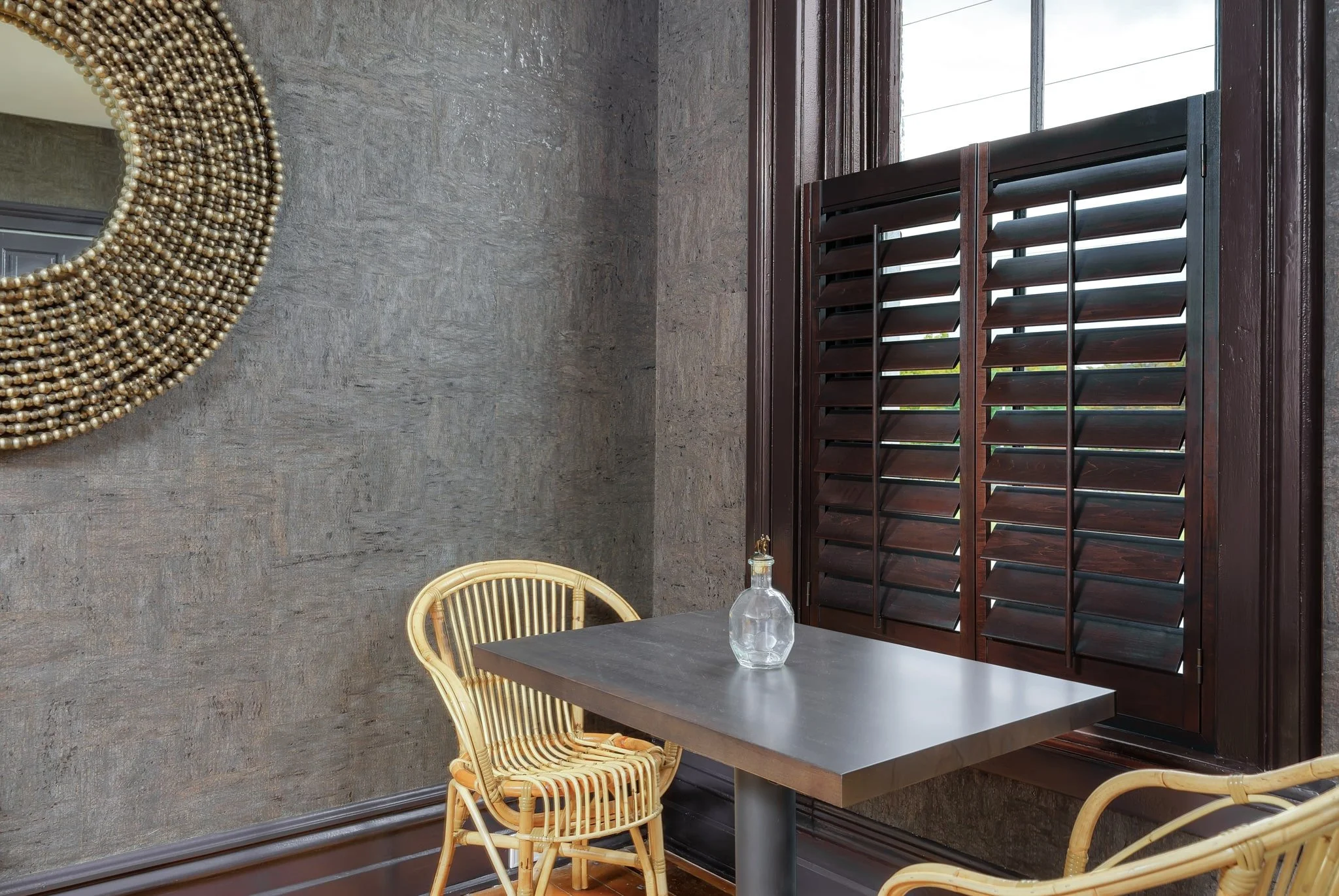 Close-up of dark wood café-style shutters at Limewater Bistro in Frankfort, Kentucky.