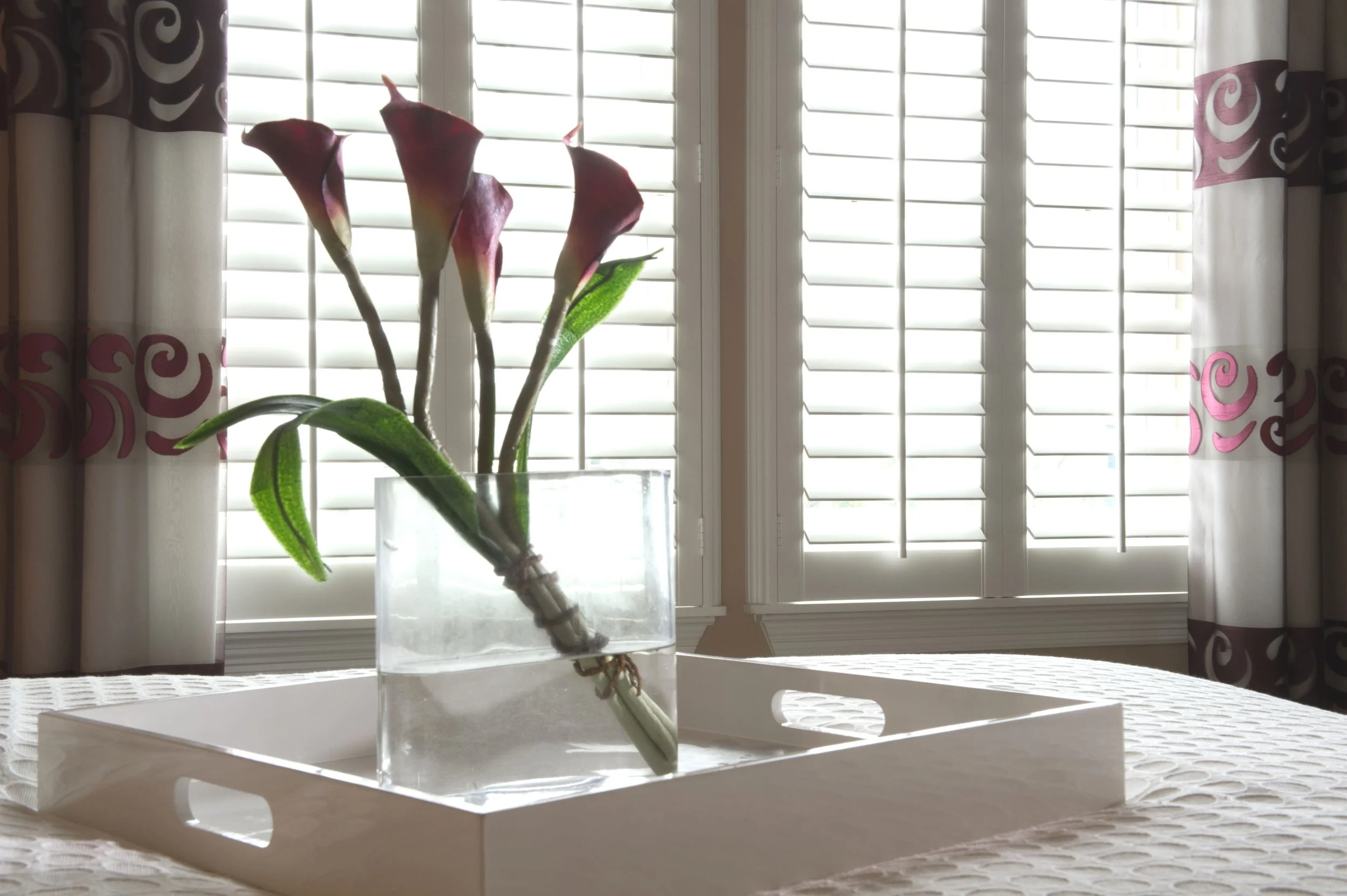 Close up photo of classic style, white painted shutters in a bedroom. Sugarland, Texas