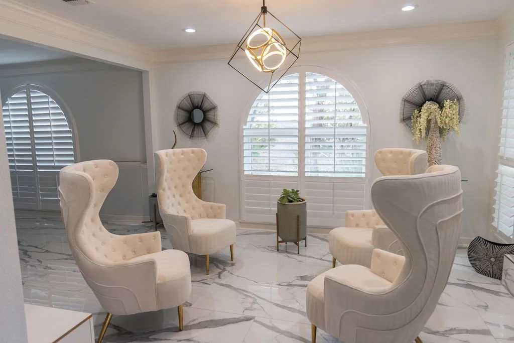 Beautiful living room in Dallas, Texas with a large arched window with Rockwood's Grand Arch shutters.