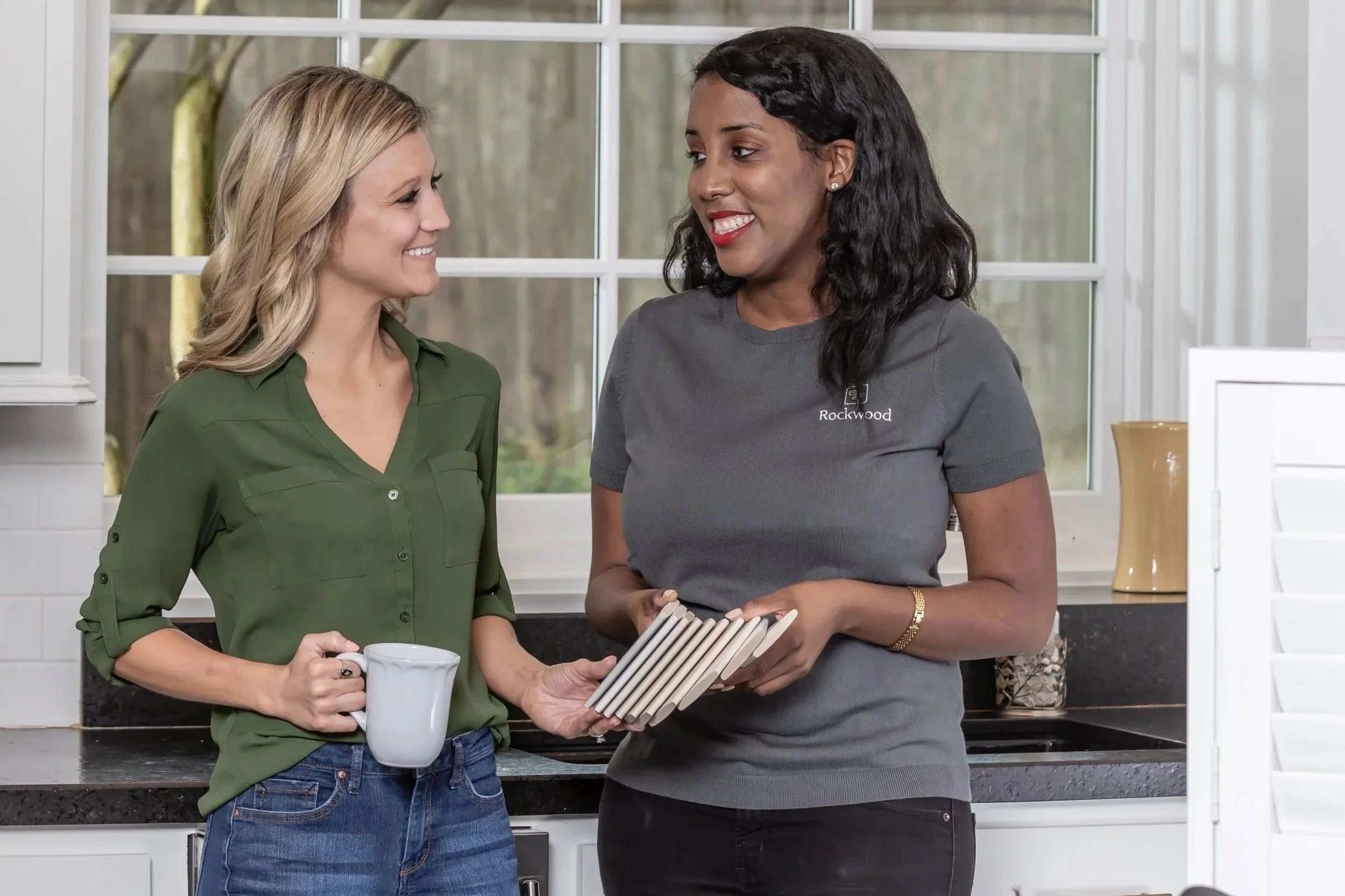 Photo of Rockwood Design Consultant showing shutter samples to a potential customer.