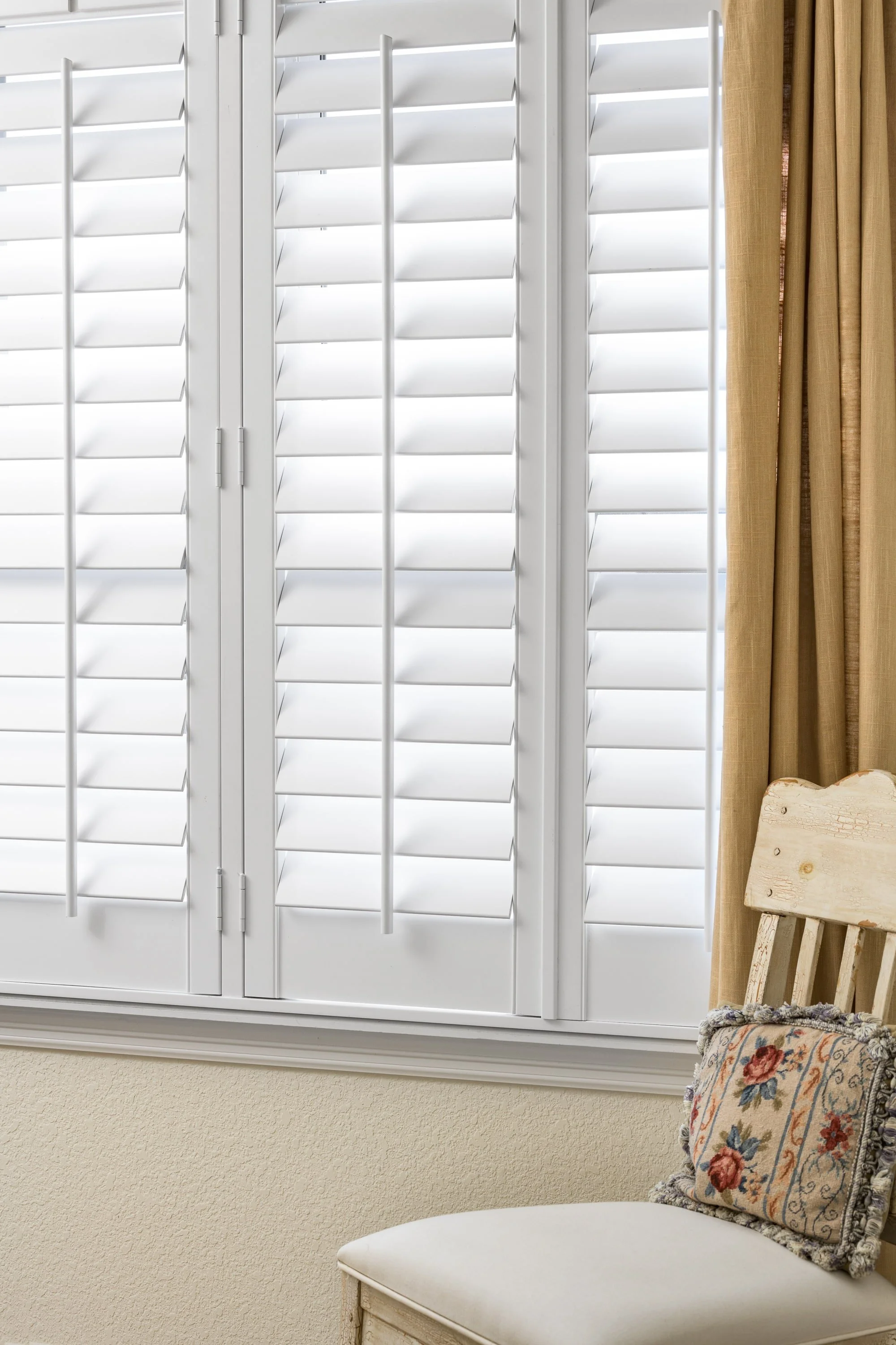 Plantation shutters in a cozy sitting area of the Colorado Classic home in Colorado.