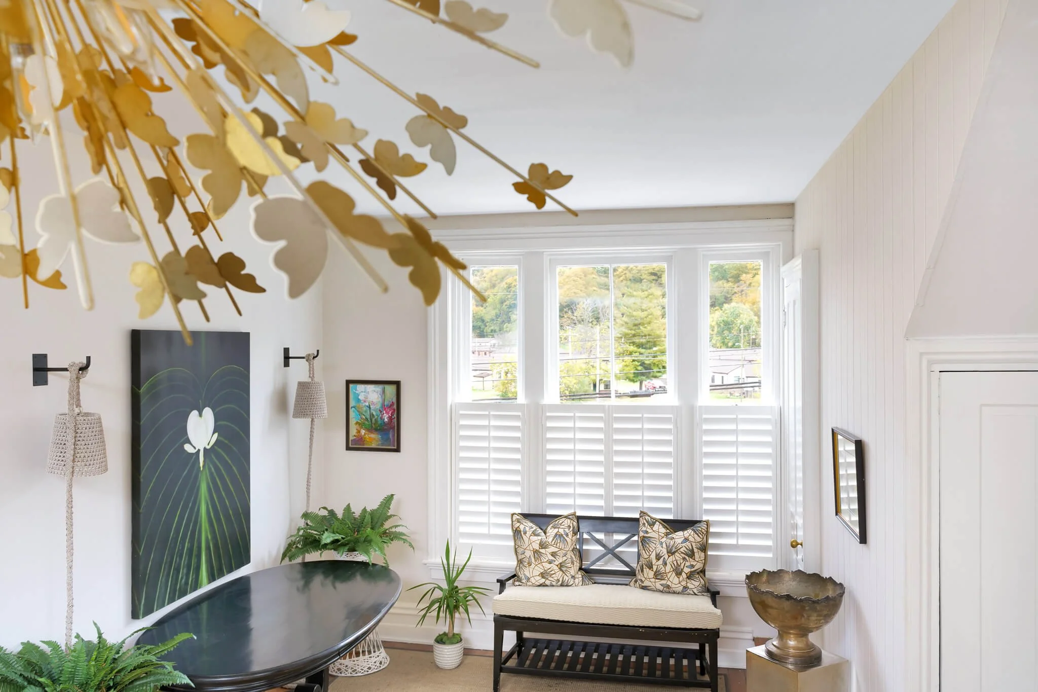 White café-style shutters provide privacy behind a window seat at Limewater Bistro in Frankfort, Kentucky.