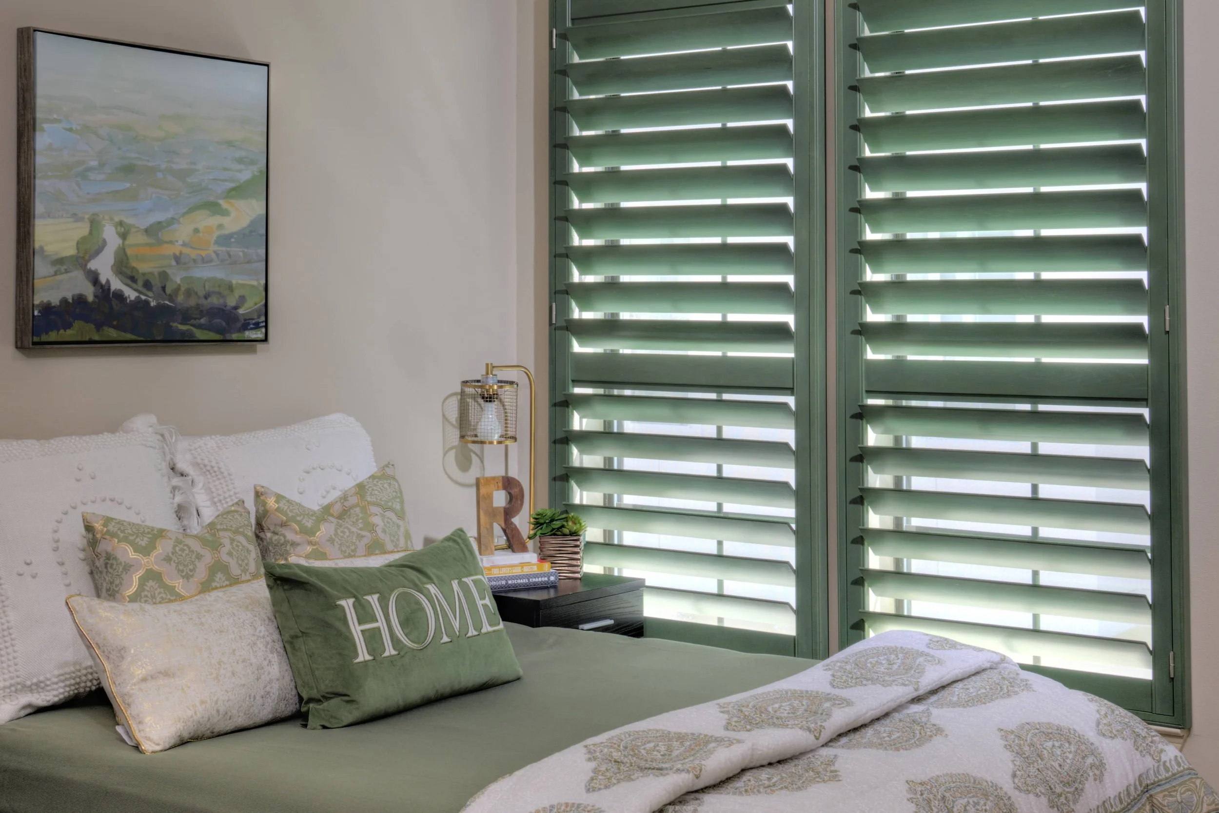 Green stained plantation shutters with ClearLine tilt complement the decor in this Chicago-area bedroom.