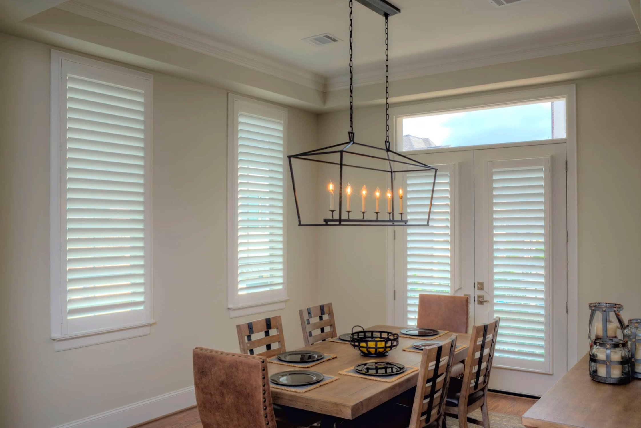 White ClearLine shutters on dining room windows and French doors in a The Woodlands, Texas home.