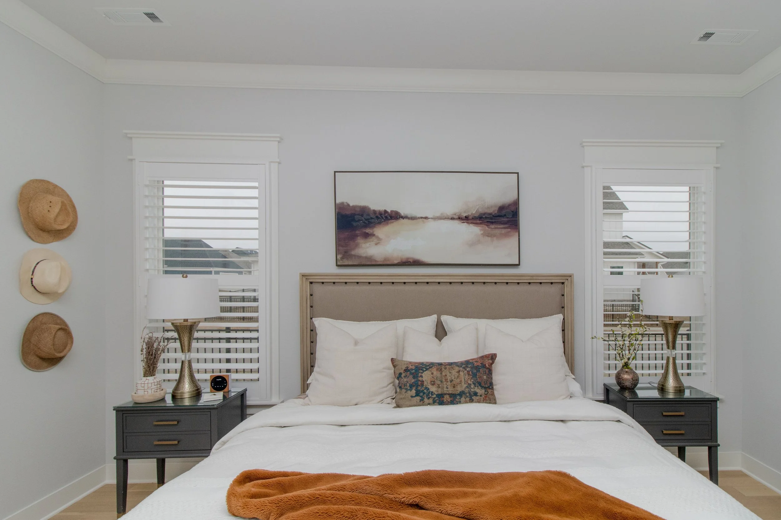 Craftsman frame shutters with bright white 3.5-inch louvers in a Northwest Arkansas bedroom.