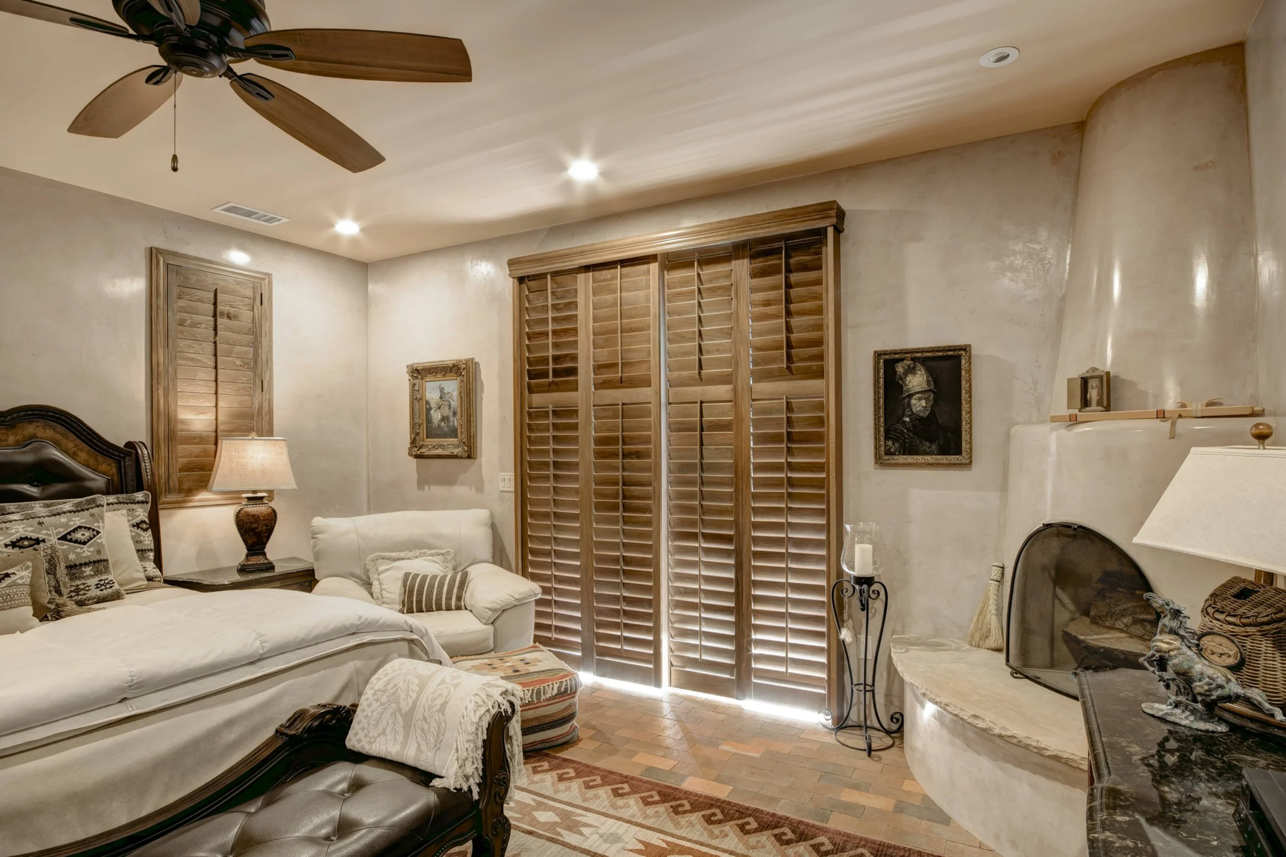 Custom hardwood shutters on a sliding glass door complement the warm Southwestern style of this Santa Fe home.