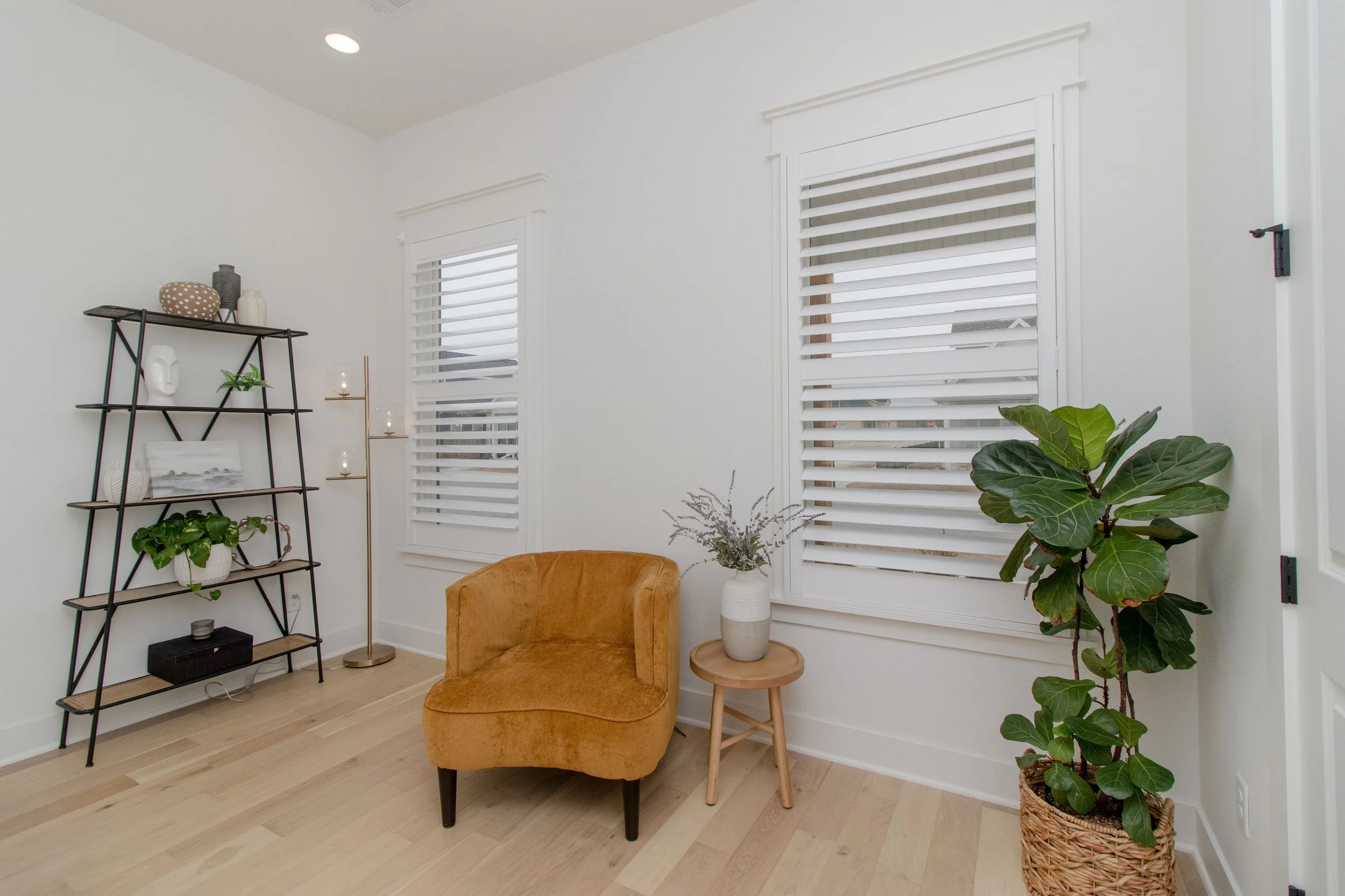 Northwest Arkansas sitting room with bright white plantation shutters and 3.5-inch louvers.