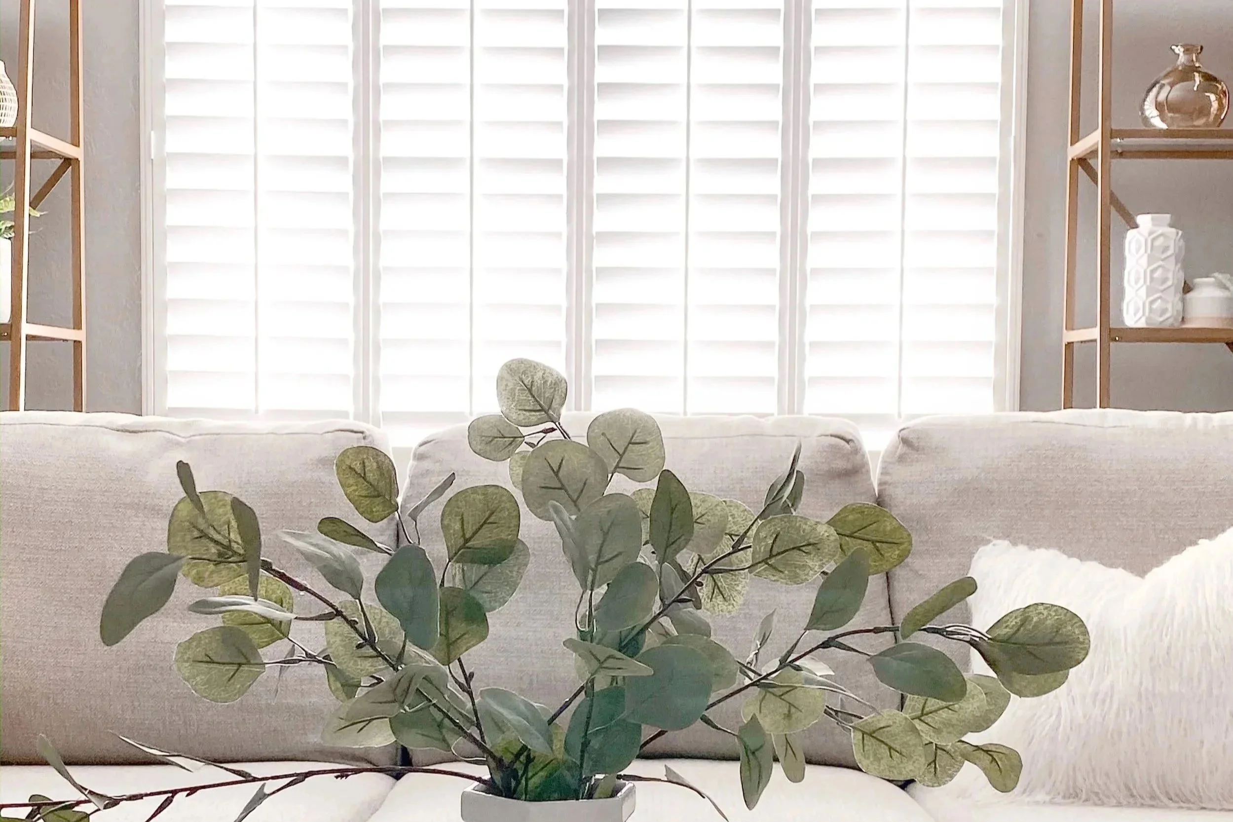 Detail view of white classic style shutters in a Dallas family room.