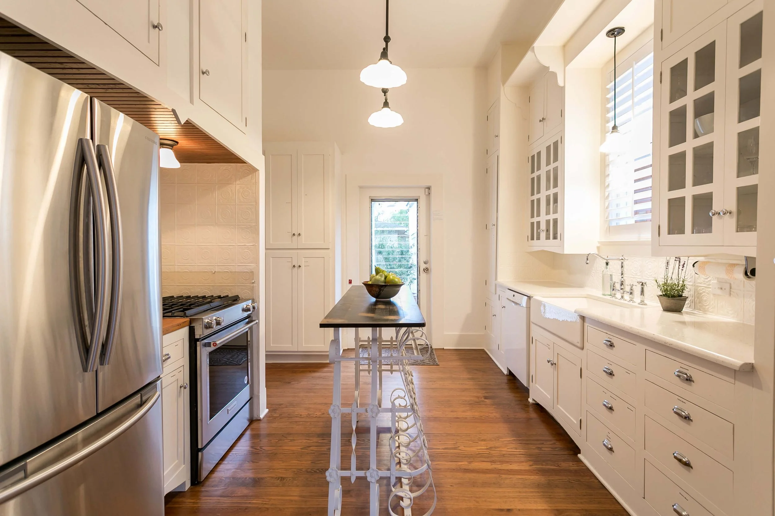 White plantation shutters over the kitchen sink in the Bella Regalo vacation rental in Fredericksburg, Texas