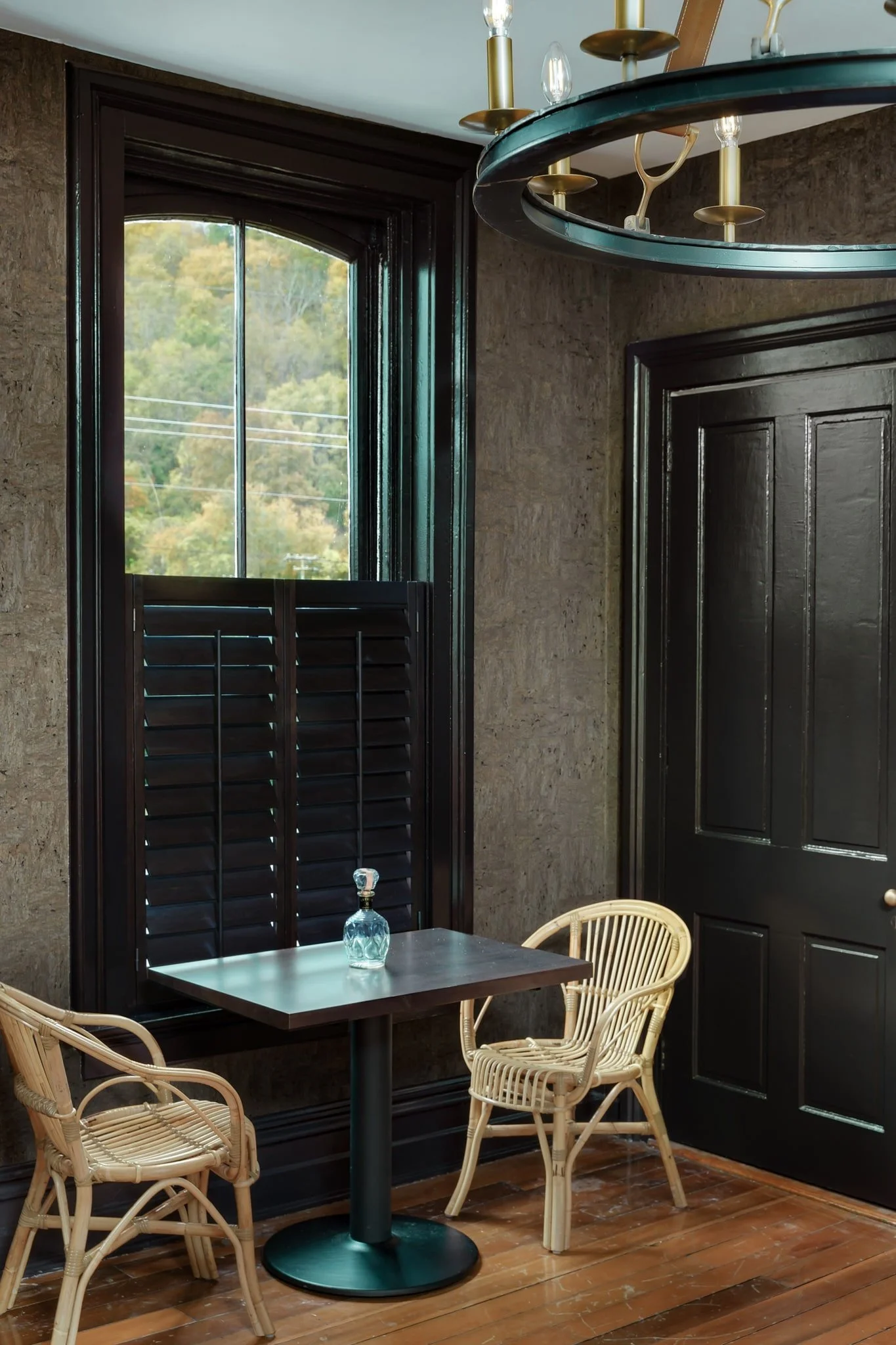 Stained café-style shutters add warmth to a dining nook at Limewater Bistro in Frankfort, KY.
