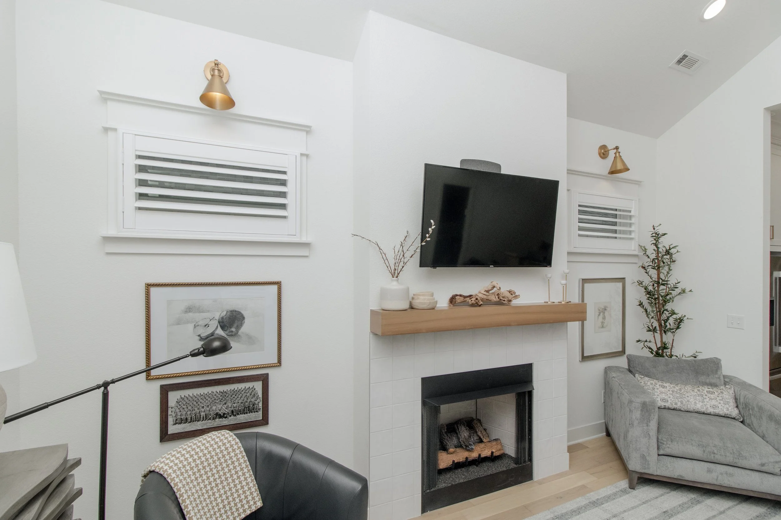 Small Craftsman frame shutters with 3.5-inch louvers beside a fireplace in a Northwest Arkansas home.