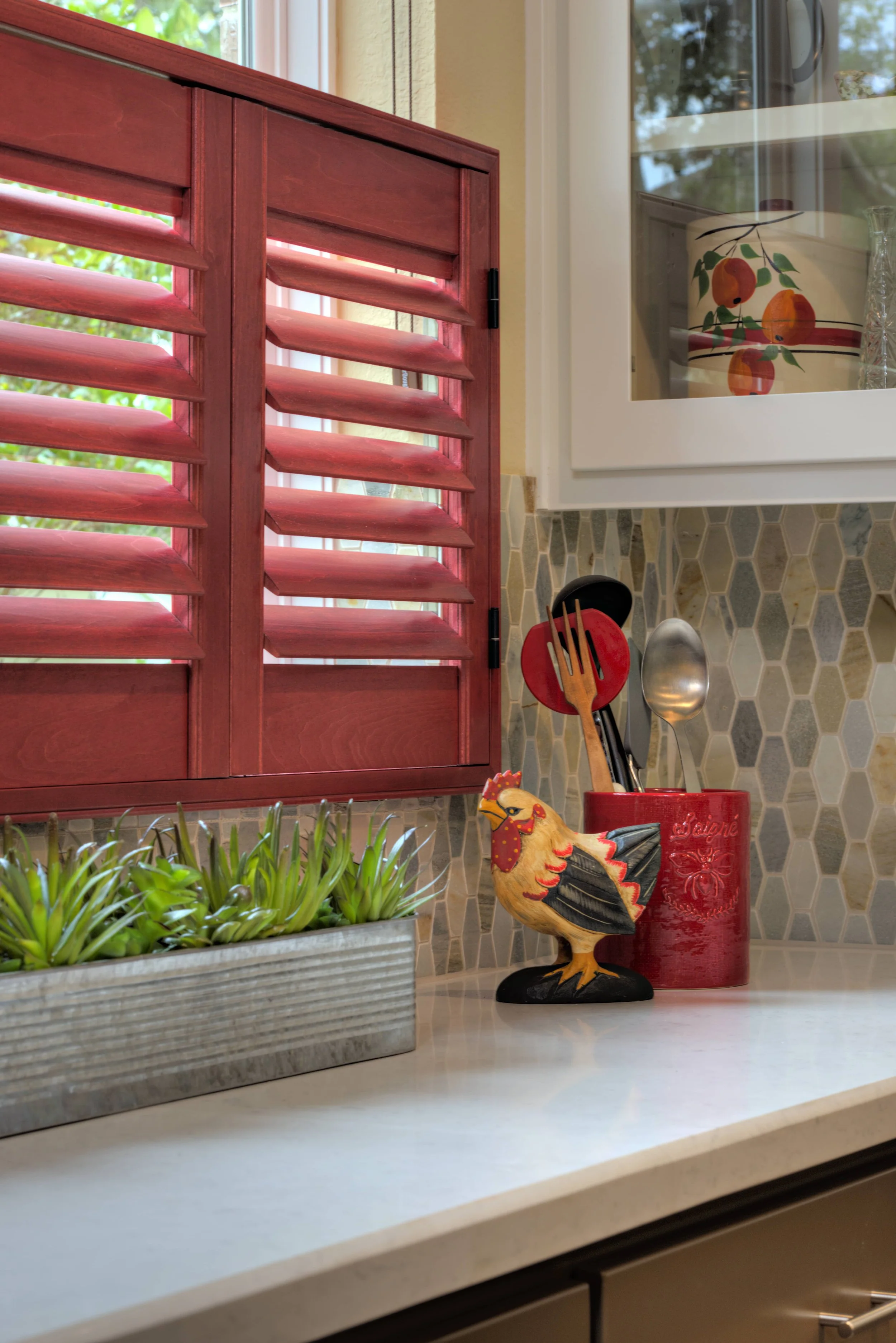 Close-up of custom red stained kitchen shutters with ClearLine tilt in a Houston, Texas home.