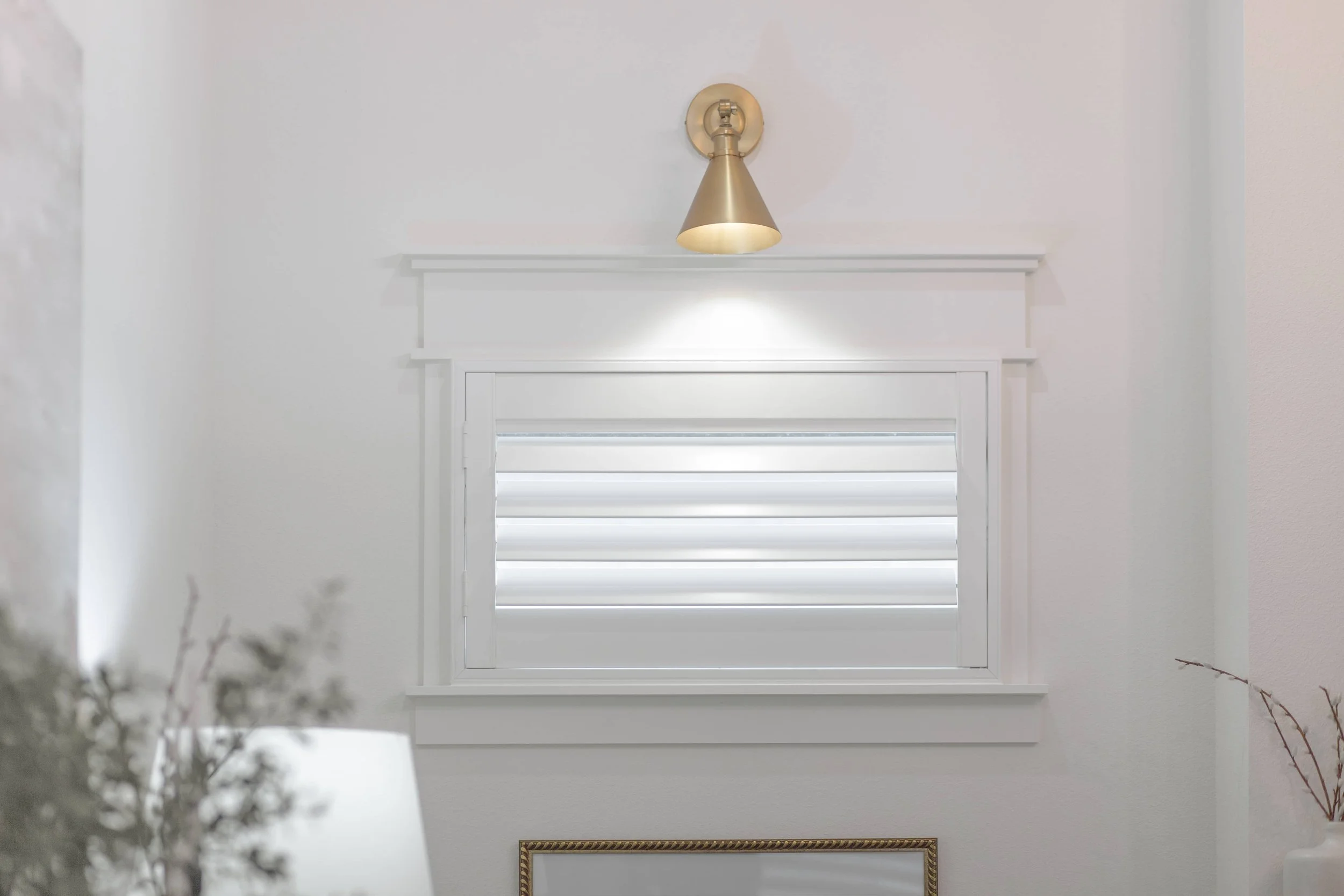 Bright white Craftsman frame shutter with 3.5-inch louvers on a small window in a Northwest Arkansas home.