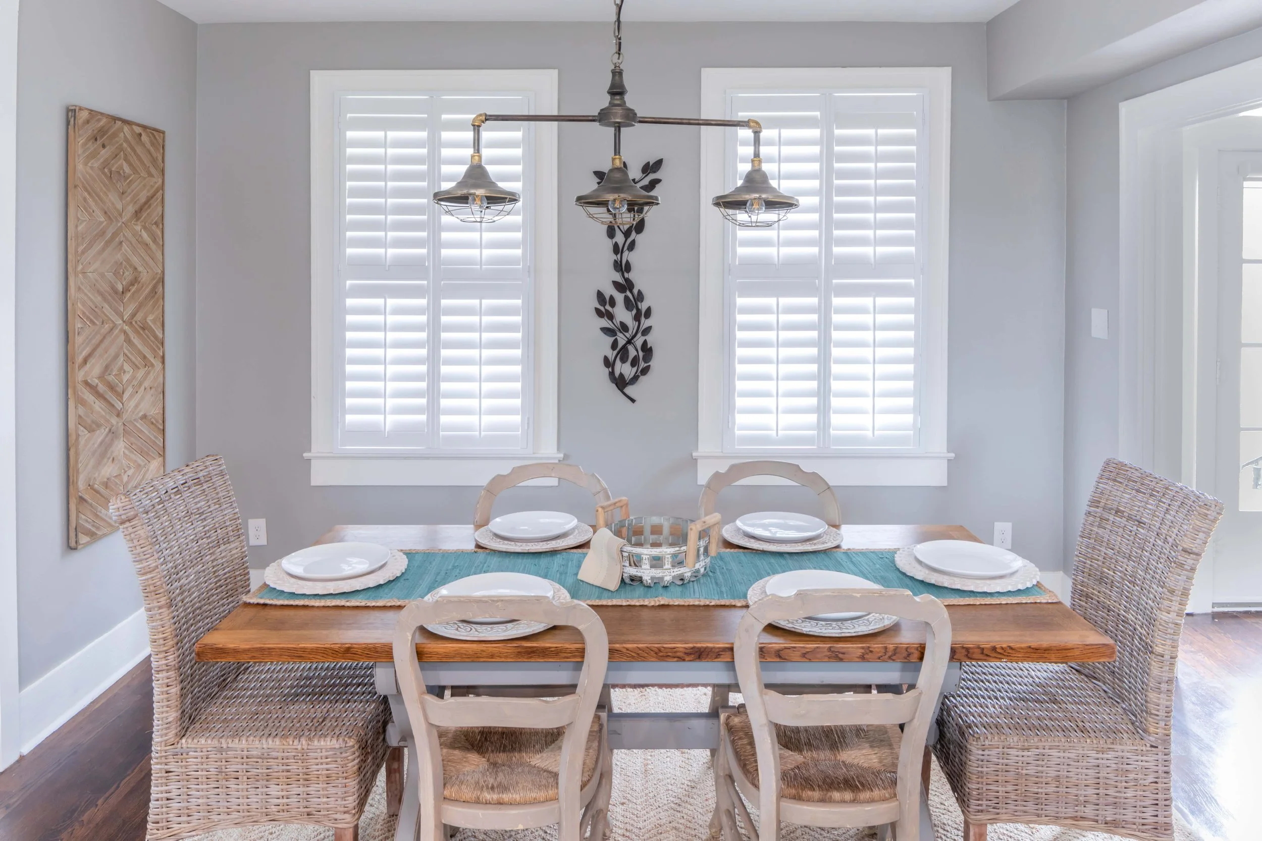White plantation shutters in the dining room of a Galveston, TX beach house.