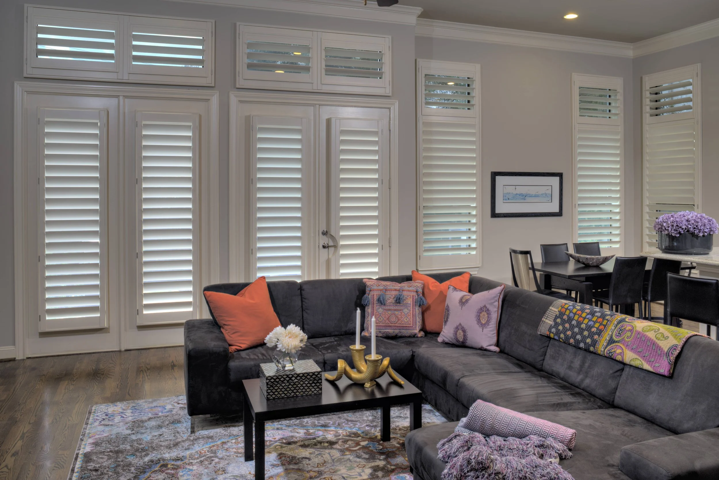 Custom white plantation shutters with ClearLine tilt cover windows and French doors in a Chicago-area living room.