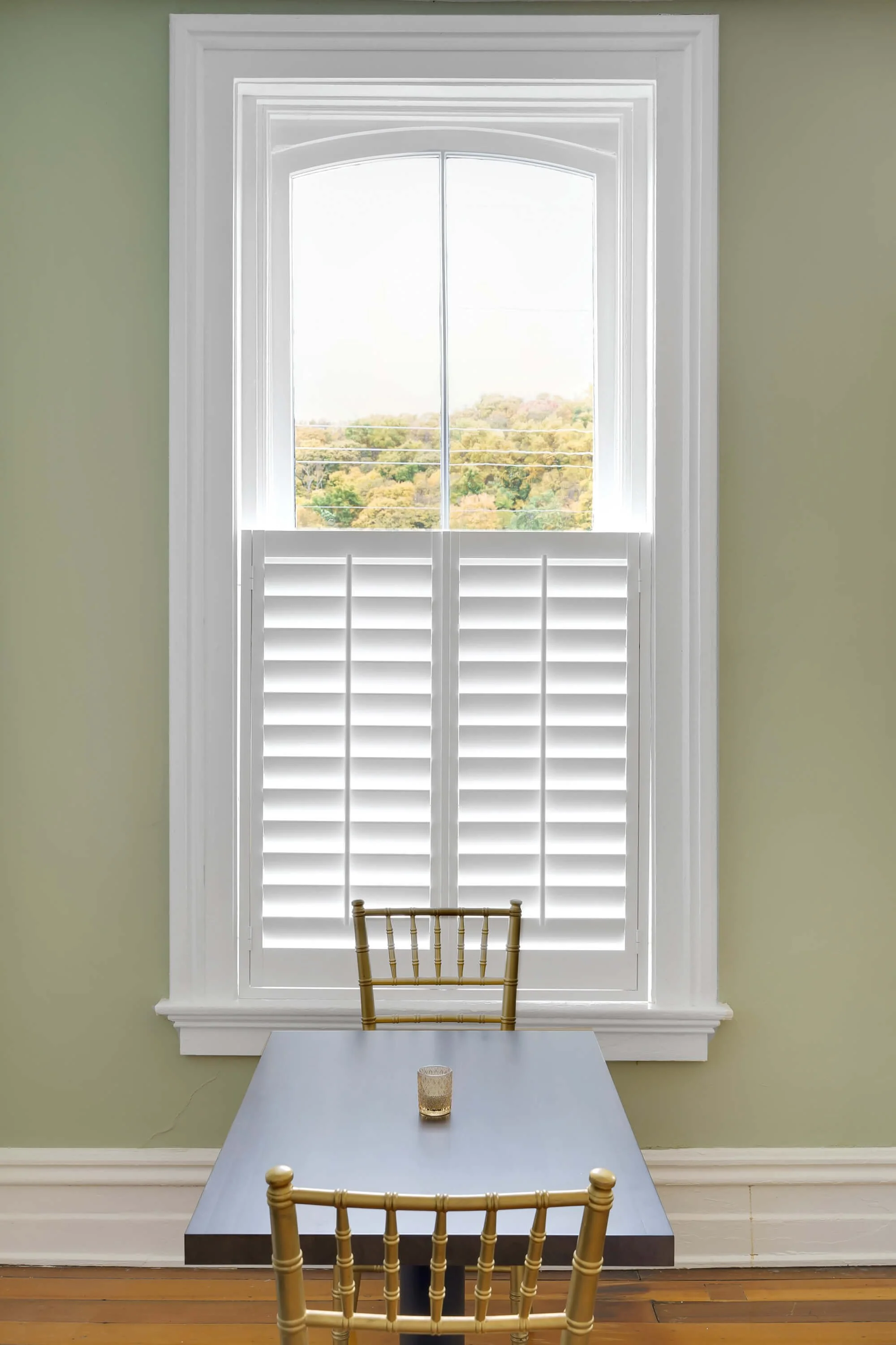 White LiteLine shutters filter natural light in the dining room at Limewater Bistro in Frankfort, Kentucky.