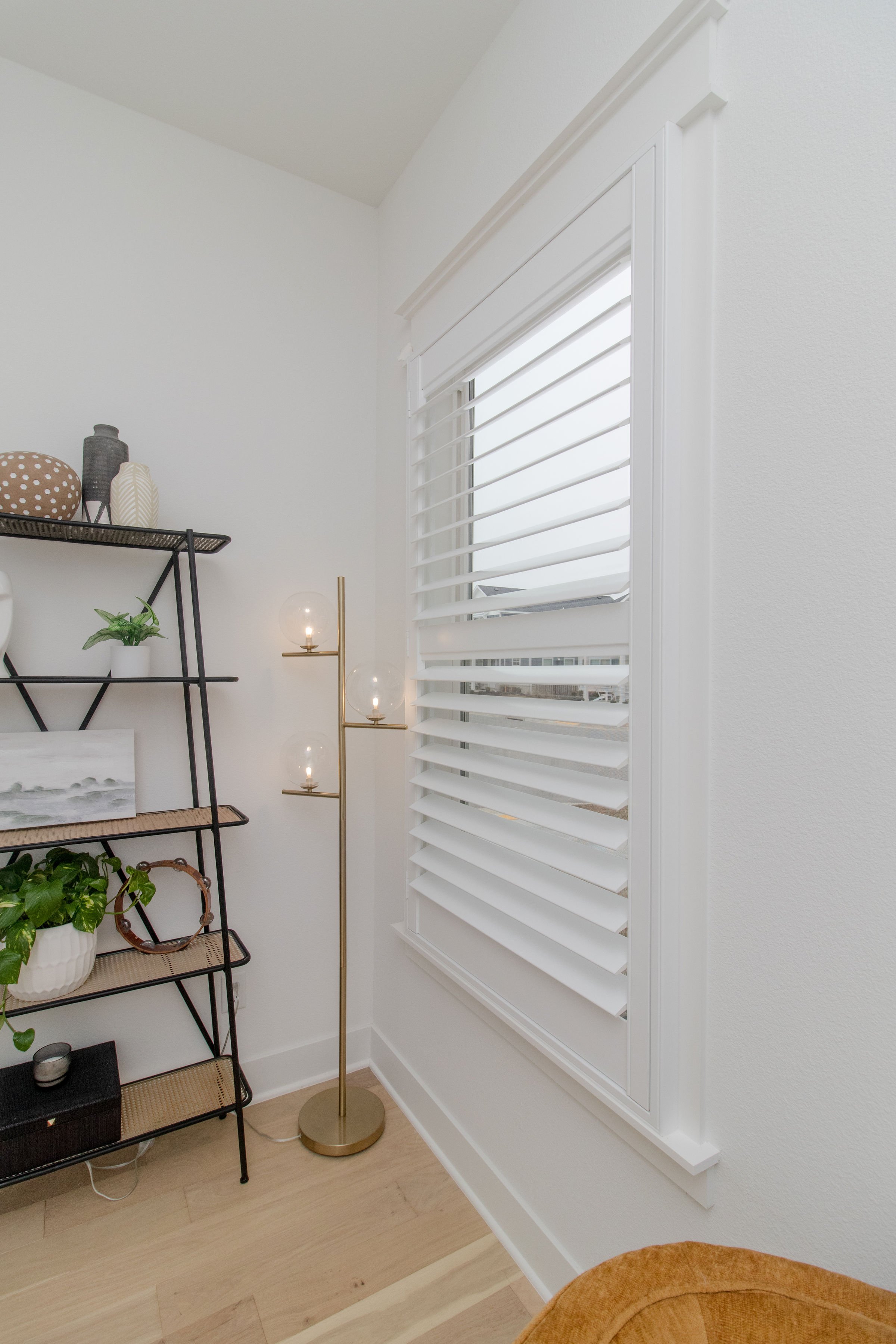 Bright white plantation shutters with ClearLine tilt on a primary bedroom window in Northwest Arkansas.
