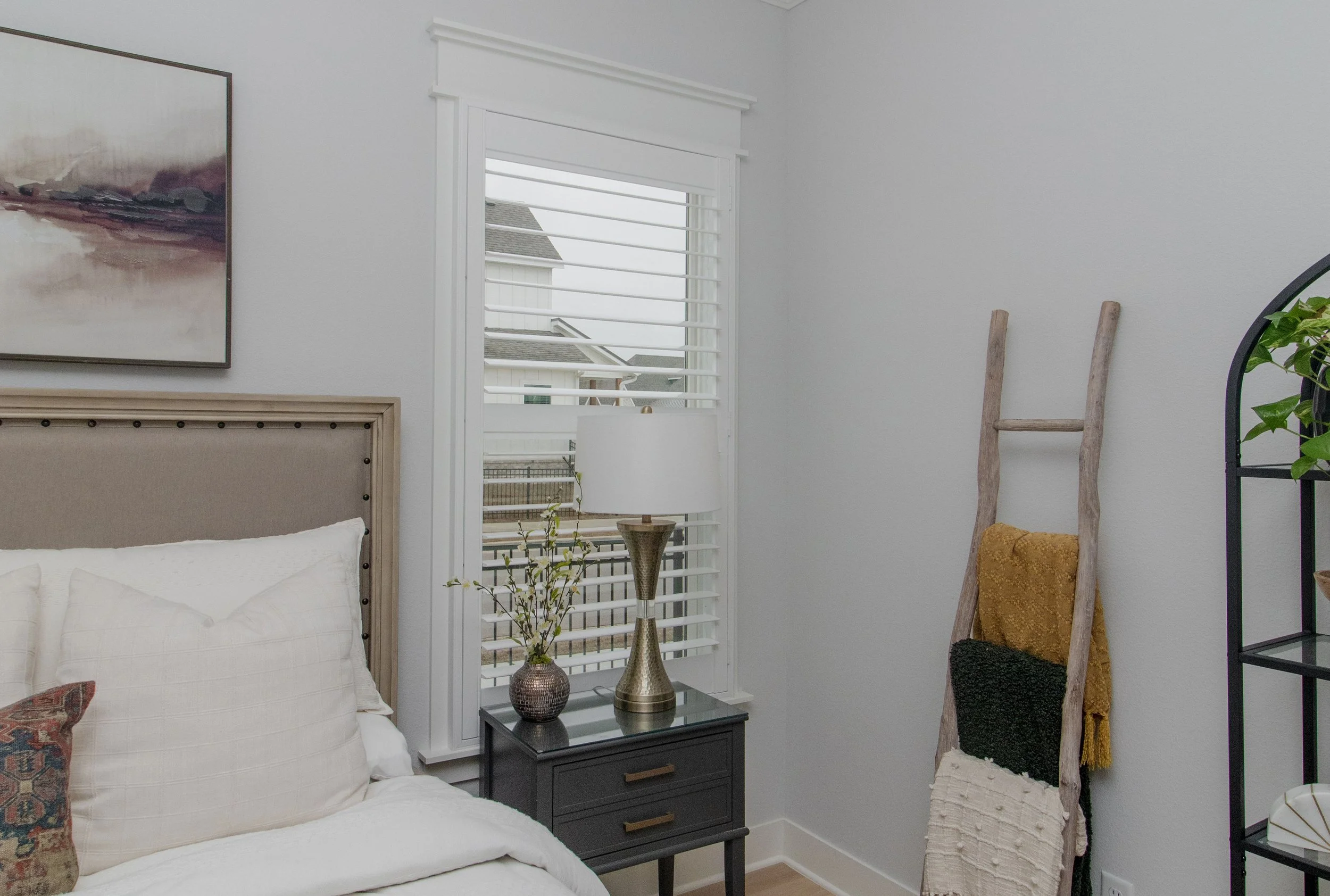 Bright white ClearLine plantation shutter with 3.5-inch louvers in a Northwest Arkansas bedroom.
