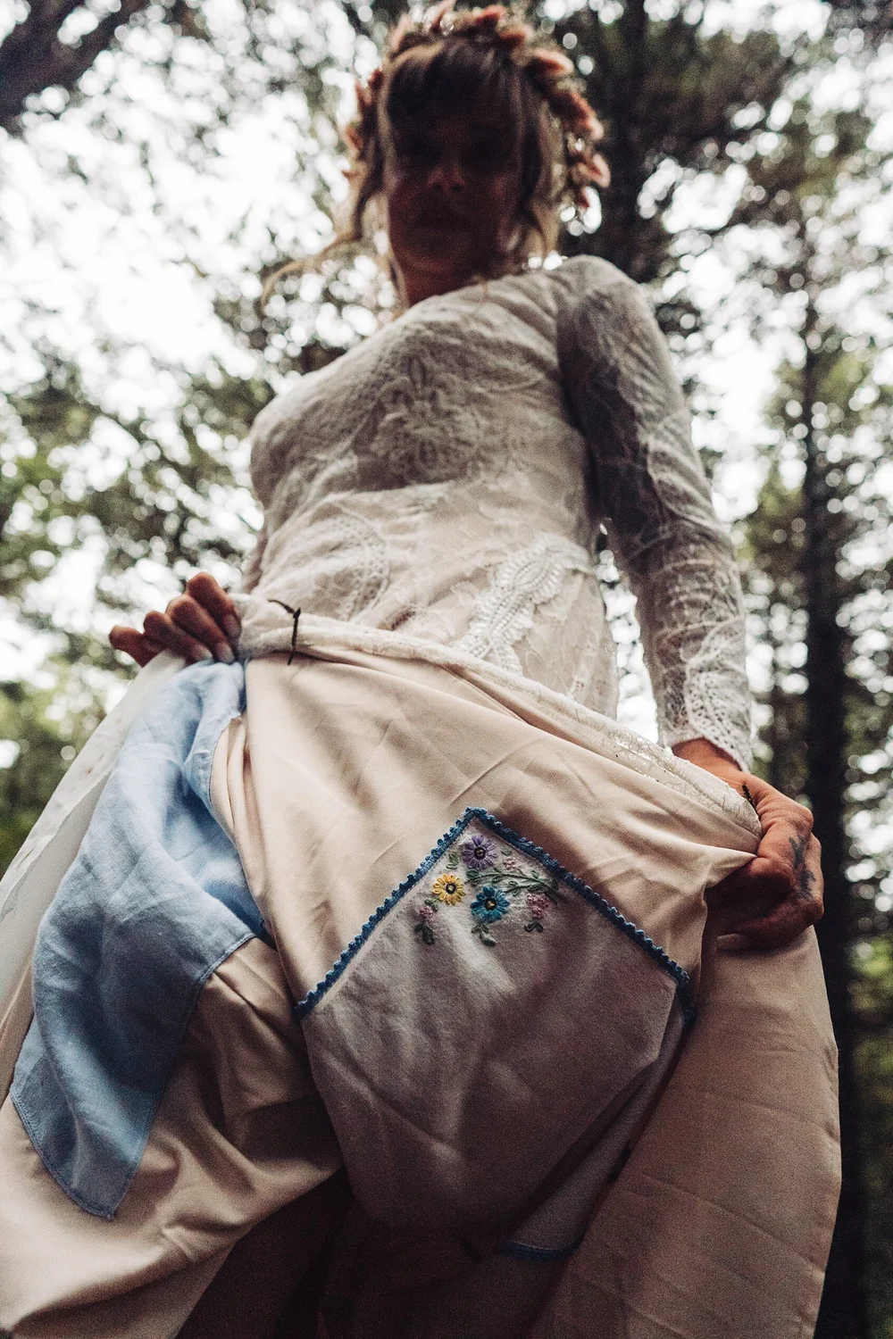 Bride showing an embroidered family heirloom sewn into the inside of her wedding dress