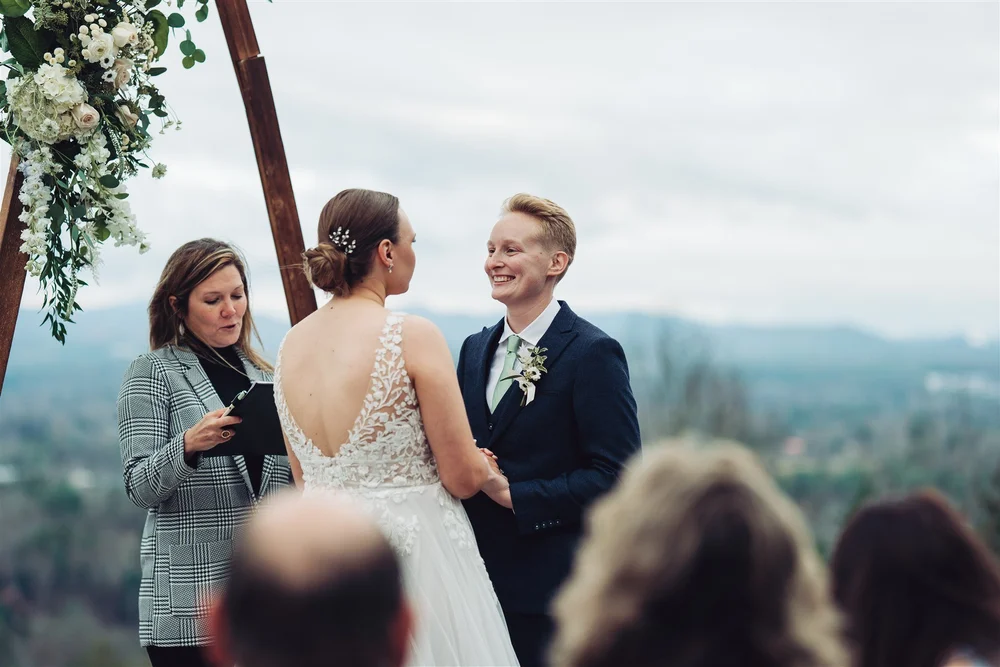Couple exchanging vows during an outdoor mountain wedding ceremony