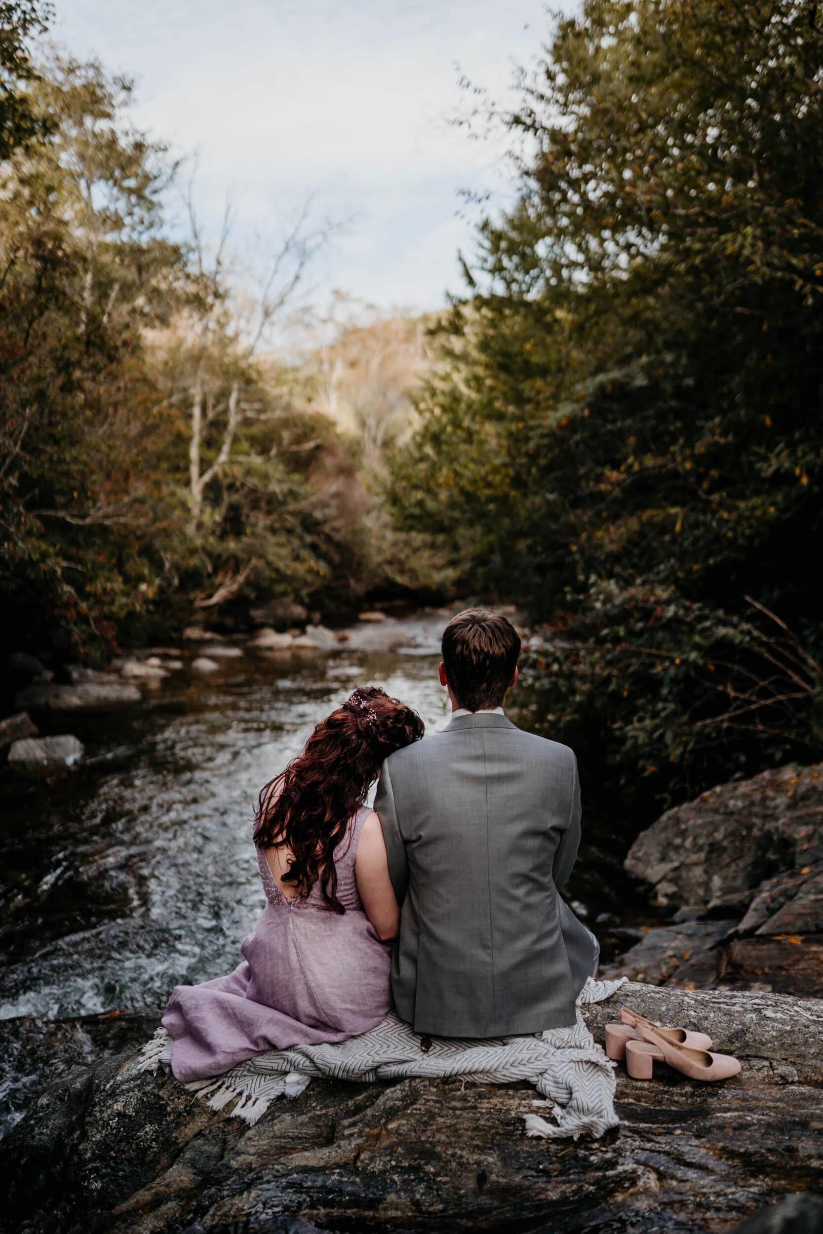 intimate-couple-by-water-outdoor-romantic-setting-forest.jpg