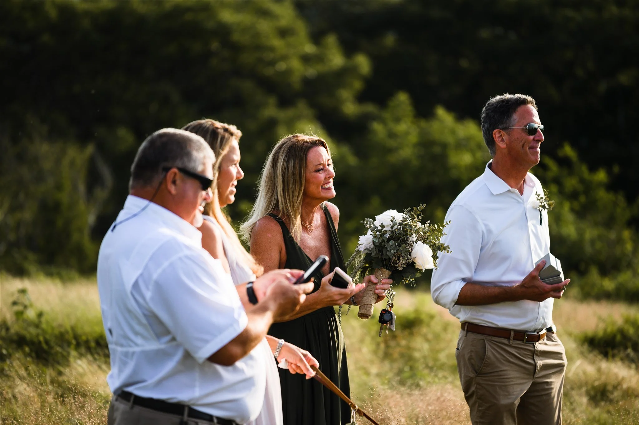 Family members sharing the excitement of a small wedding ceremony in the mountains.