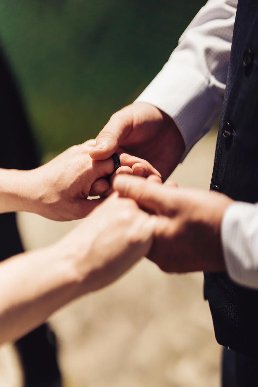 Andrea and Adam holding hands during their mountain wedding ceremony