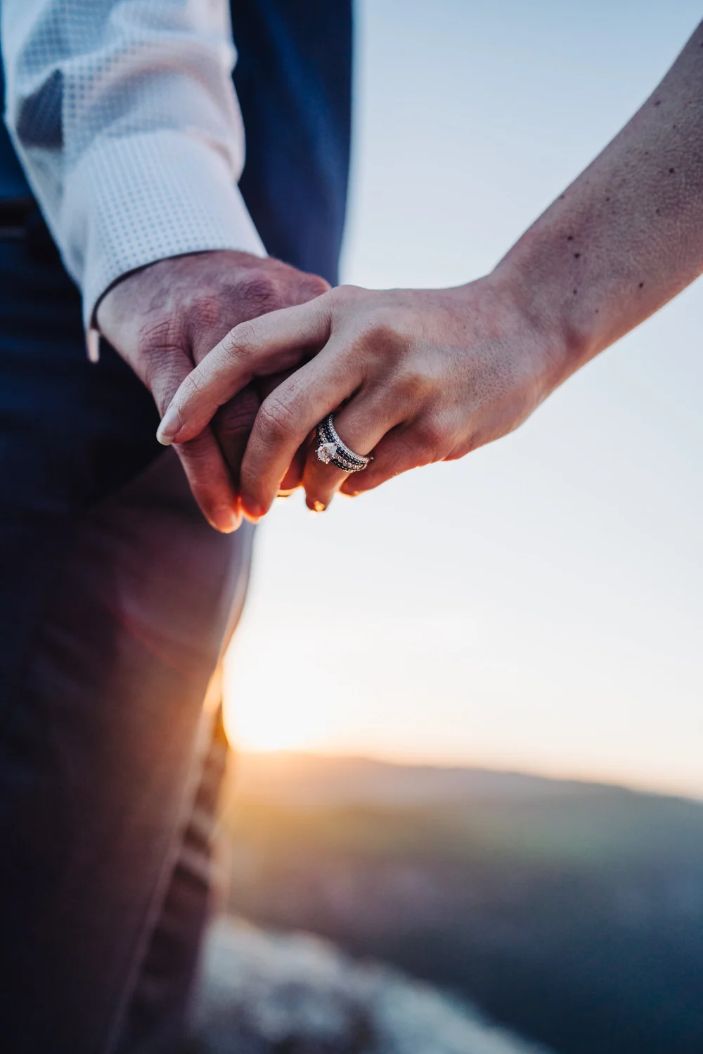 Andrea and Adam holding hands during sunset after their mountain elopement