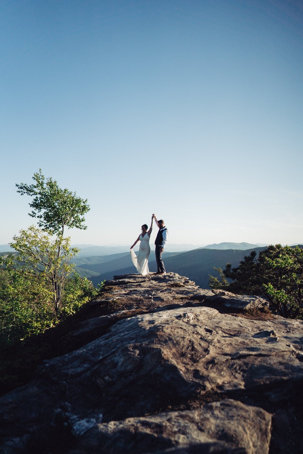 Andrea and Adam walking together across the rocky landscape during their mountain elopement